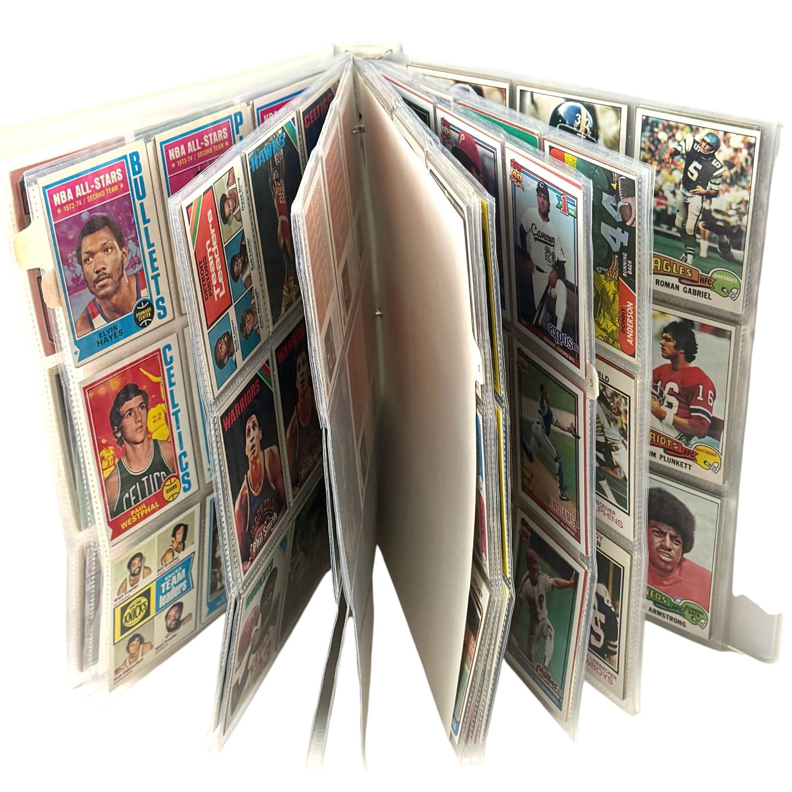 Mixed Sports Binder, 70s and 80s, Baseball Basketball Football: Group of cards, ungraded but many in fine condition. Likely from a Wisconsin sports fan homer. Highlights include Abdul-Jabbar, Jordan, Oscar Robertson, and more. Refer to images. Approximately 350 ca