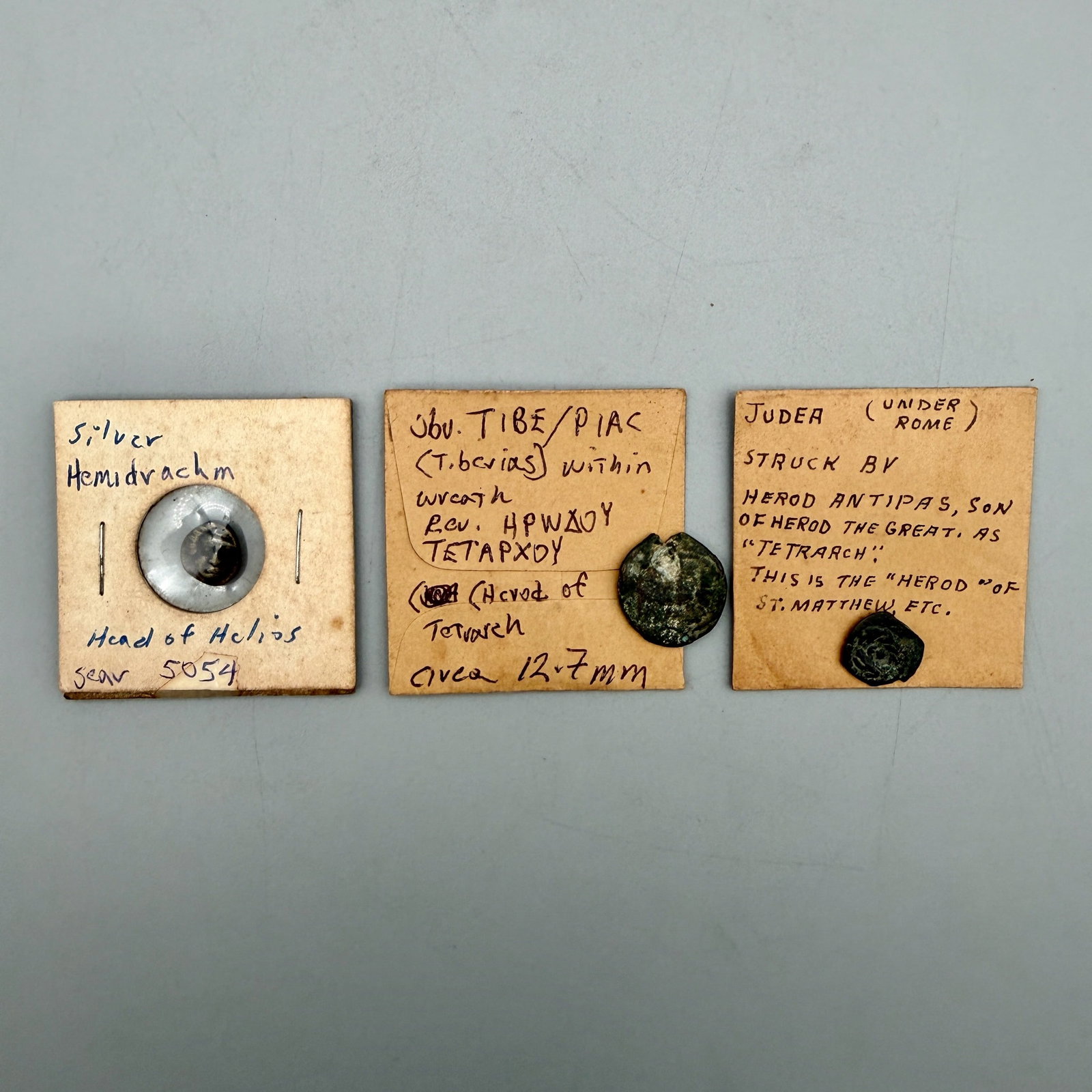 Group of Rhodos and Judea Ancient Coins: Includes two Herod Antipas bronze coins (4 B.C.â 40 A.D.) with palm branch reverse and laurel wreath obverse, plus Rhodos silver hemidrachm (408â 390 B.C.) with head of Helios and rose reverse.