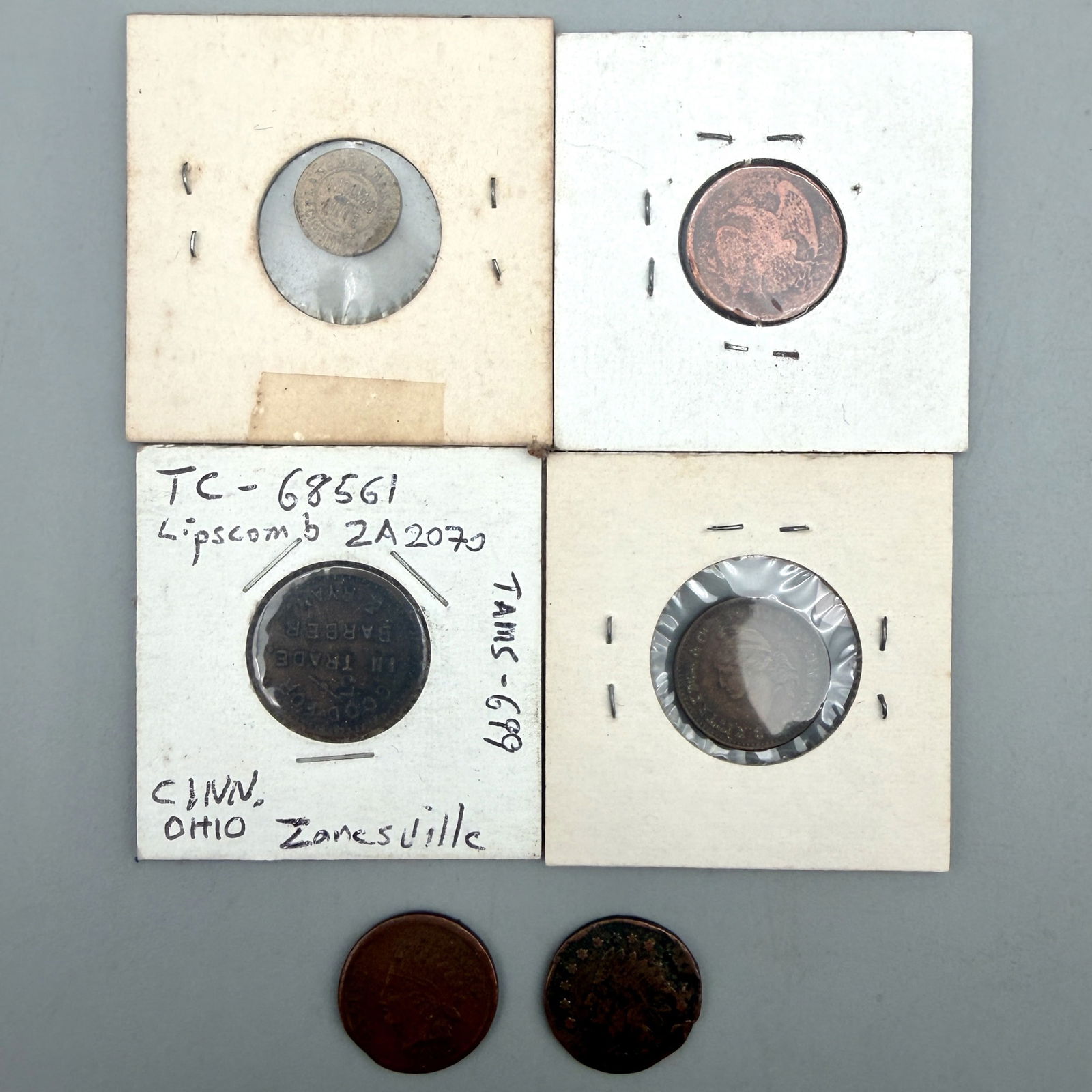 Group of Ohio Civil War Tokens: Five Ohio Civil War trade/store tokens including Zanesville 5¢ Barber & Ryan; Dayton Rickey’s Book Store; Steubenville J.W. Gray; Cincinnati B. Kitteridge arms dealer; Broas & Eckert; and brass Wid