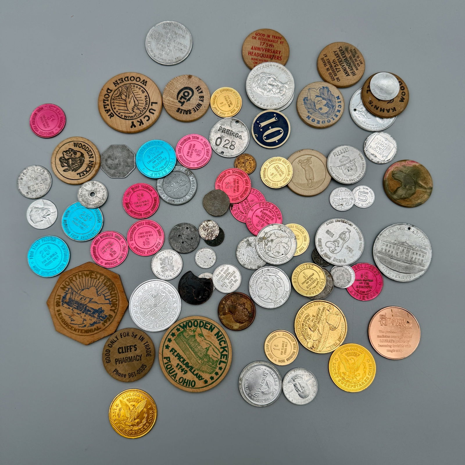 Seventy-Two Tokens From 1933-1990s: 72 mixed tokens (aluminum, zinc, wood, lead, copper, paper, cello, stainless, tin, plastic, clay) including advertising, play money, tax tokens, commemoratives, food stamp tokens, wooden nickels, and