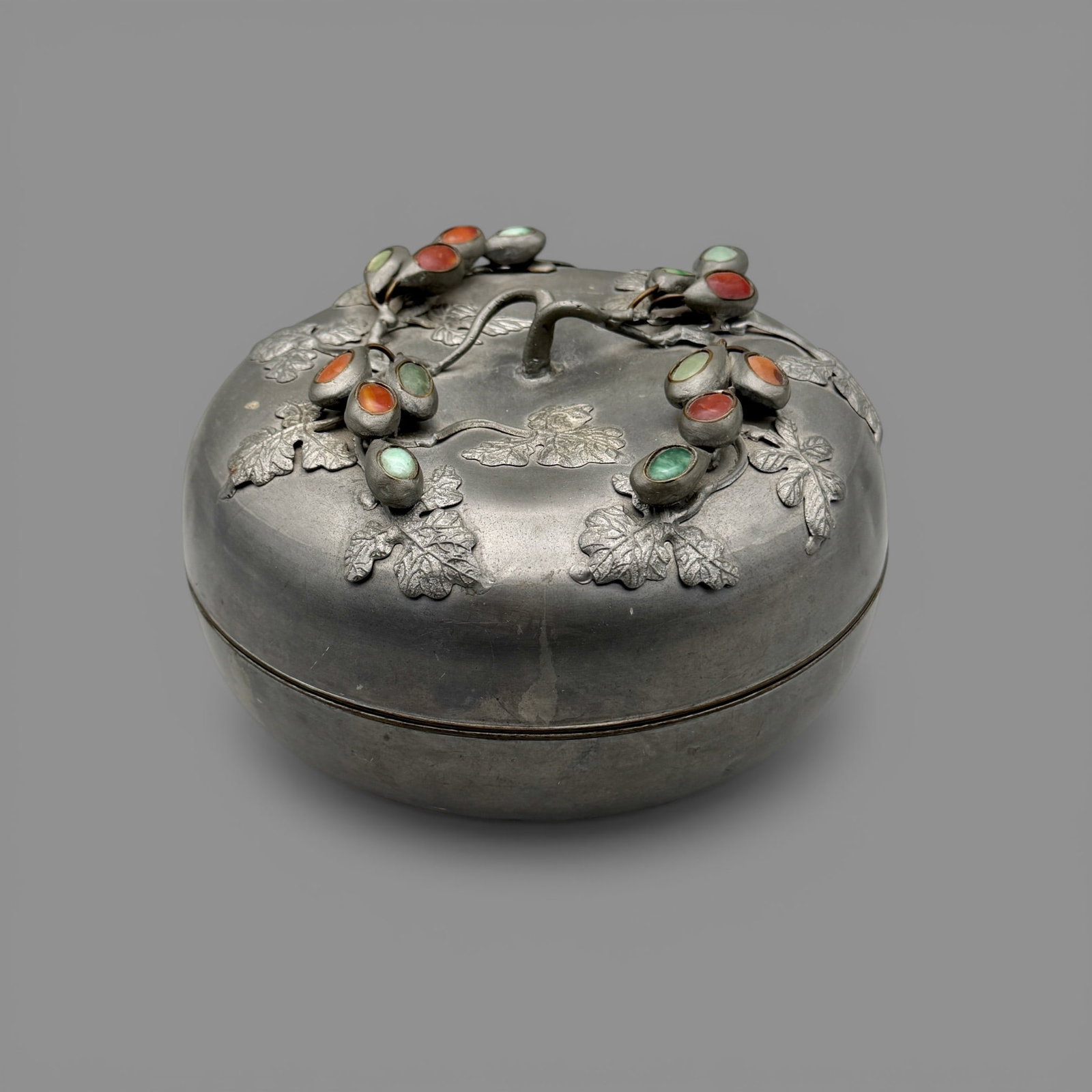 Pair of Japanese Jar/Vase: One cloisonne vase with flying bird decoration and a Japanese-style covered dish decorated with vines and gemstones in metal. Tallest height: 7.25"