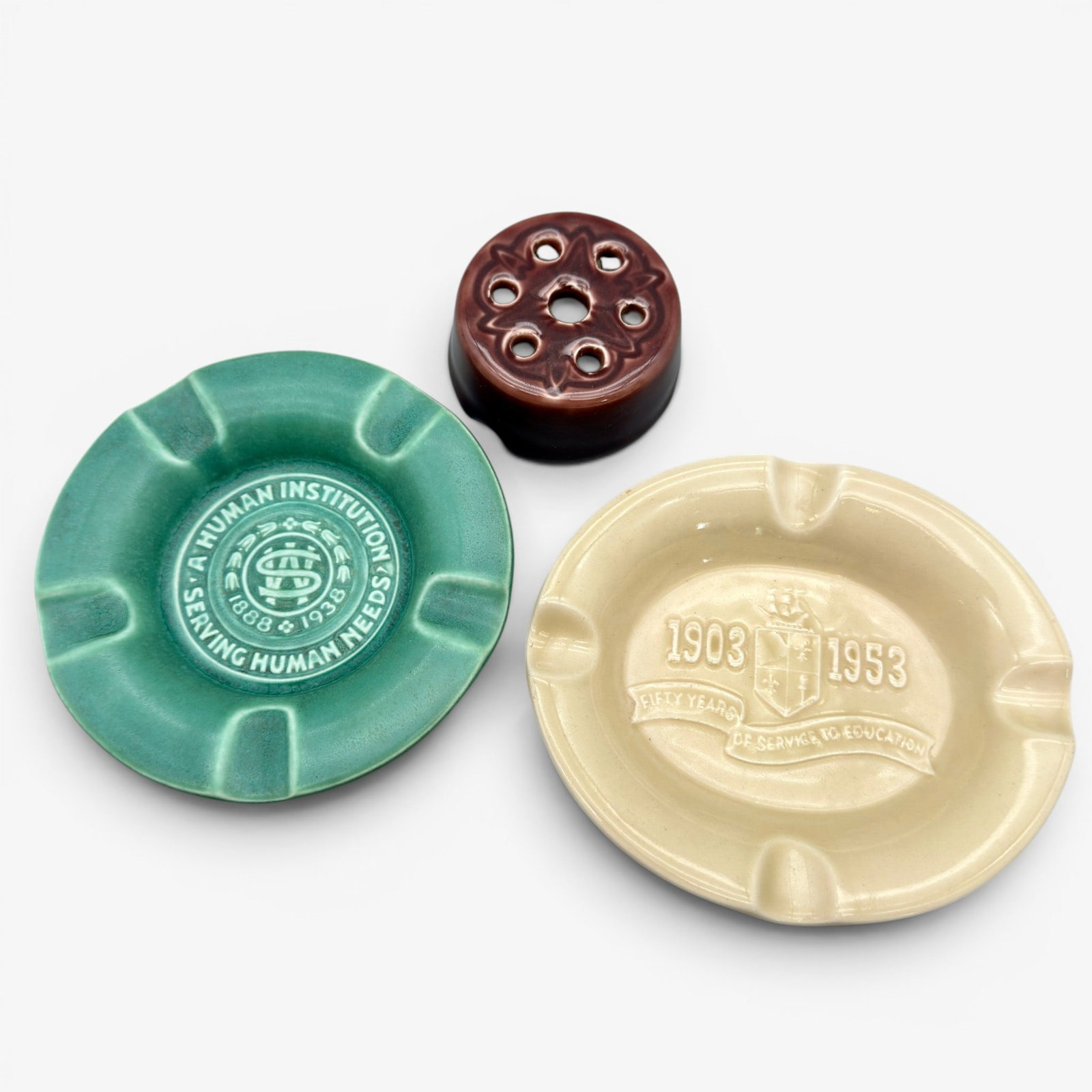 Three Rookwood items, flower frog and two ashtrays. (1 of 4)