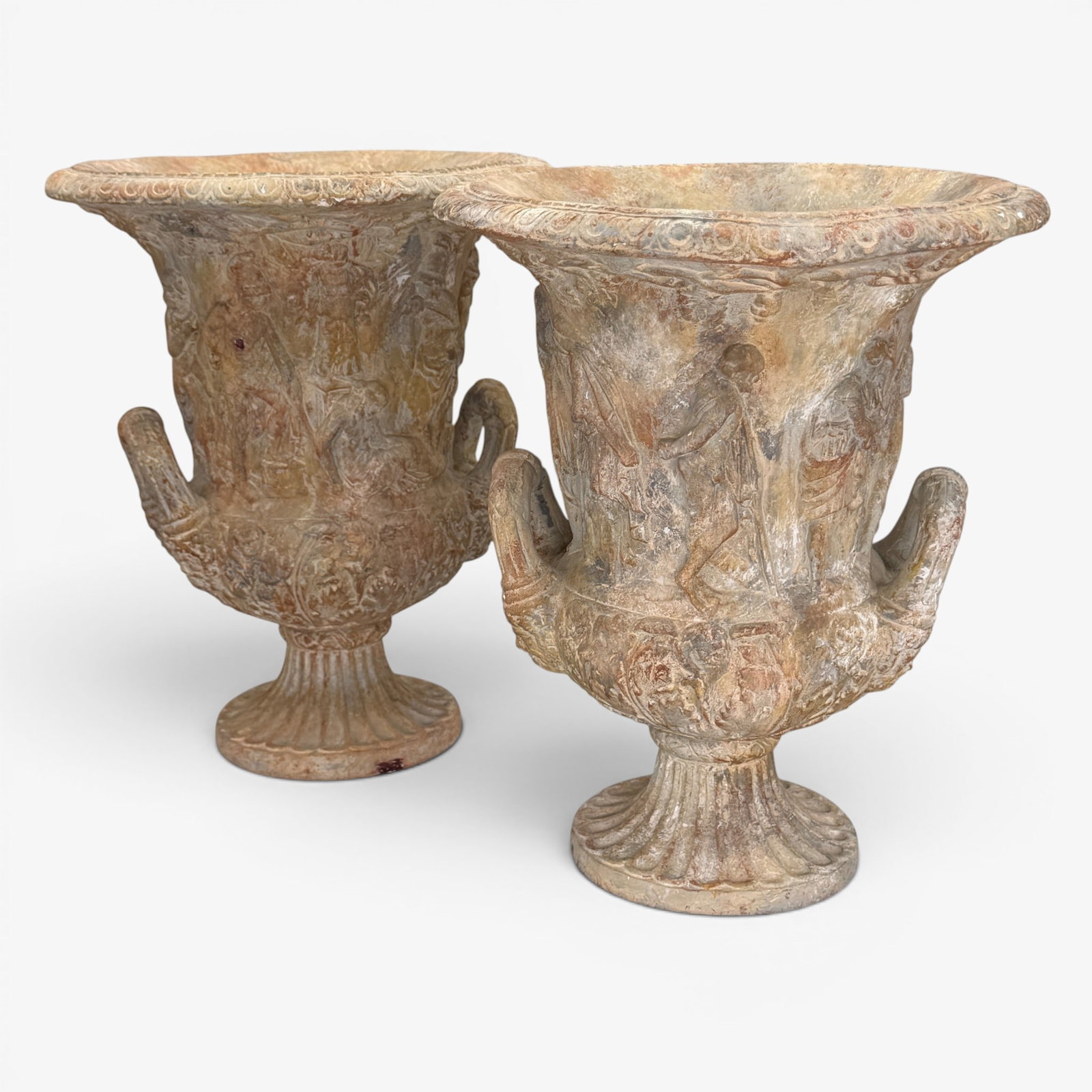 Pair of Roman Style Terracotta Urns: A pair of 20th century relief urns, with handles, in the style of ROman pottery. Ht. of each 10.5".