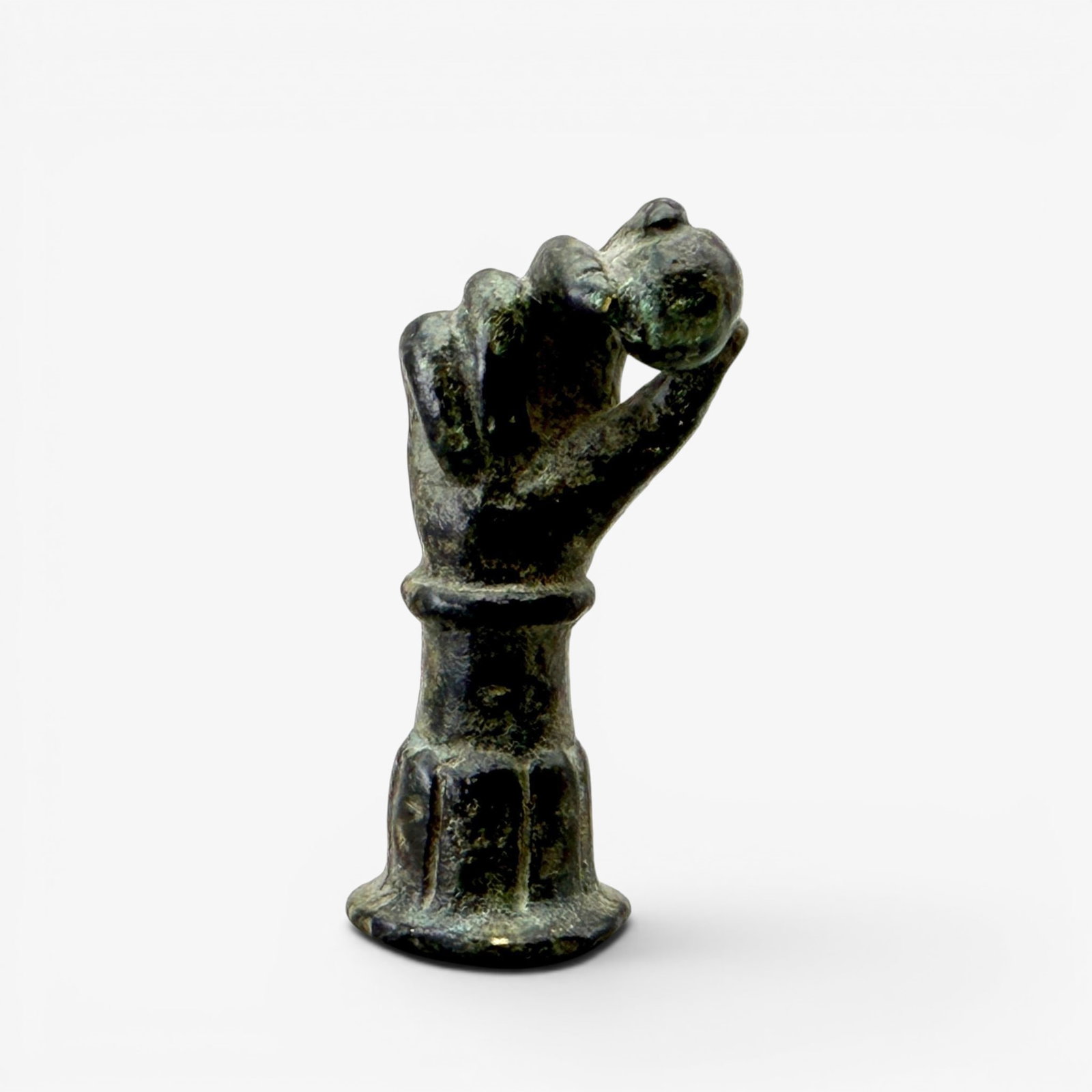 Roman Bronze Hand with Orb: A small Roman bronze cast hand with ball, including an analyses by Akron, OH dealer. Ht. 2".