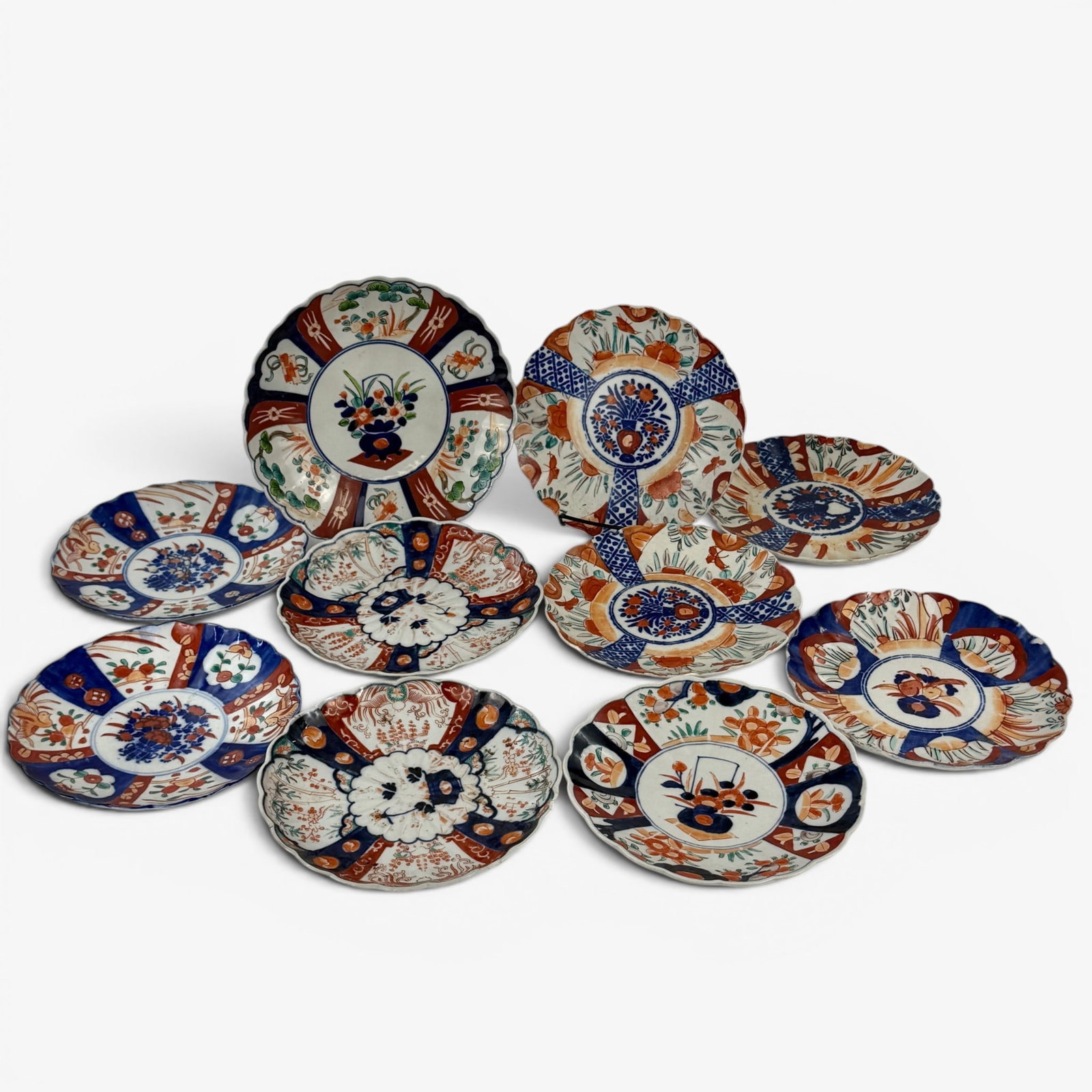 Collection of Chinese Imari Wares: 19th century, a collection of scalloped rim dishes, one charger, and bowls. Largest diameter 13".