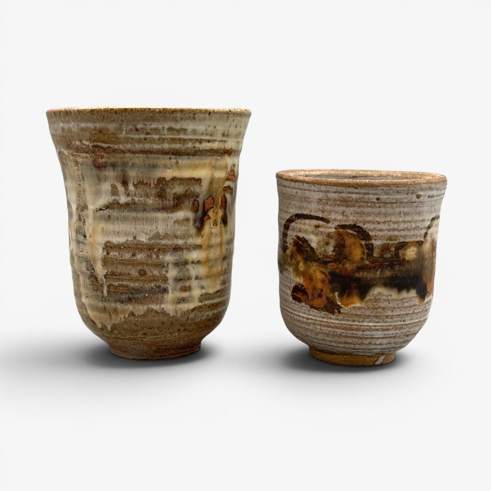 Two handthrown vases attributed to Tom Collins.: Two handthrown vases with gray-brown glaze, attributed to Tom Collins. The same illegible signagture on both which does not correspond with Collins' marks. Paper label on one is marked "Tom Collins."