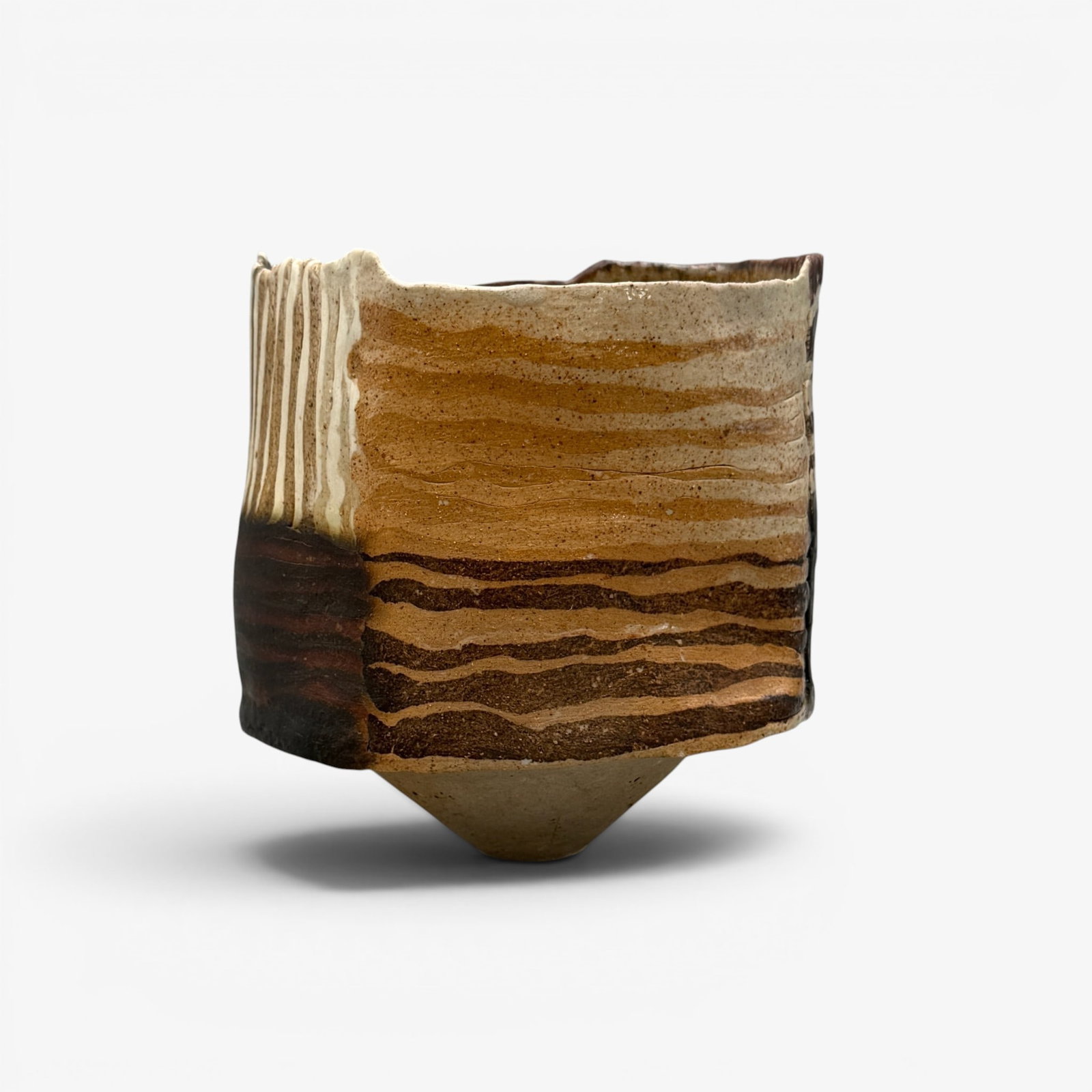 Hand built ceramic vessel, striped clay panels.: Hand built ceramic vessel made up of striped clay panels, arranged horizontally or vertically. Signed RD in black on the small base. Height 6 1/8 inches, diameter 5 1/2 inches.