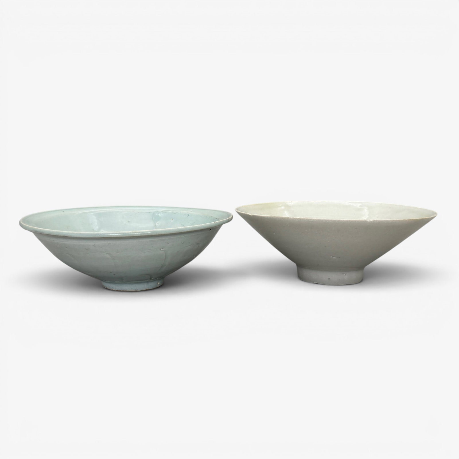 Pair of Song Qingbai Ware Bowls: Each song, with carved interiors, one bowl with later inscription to underside, each boxed. Diameter of largest 6.75".