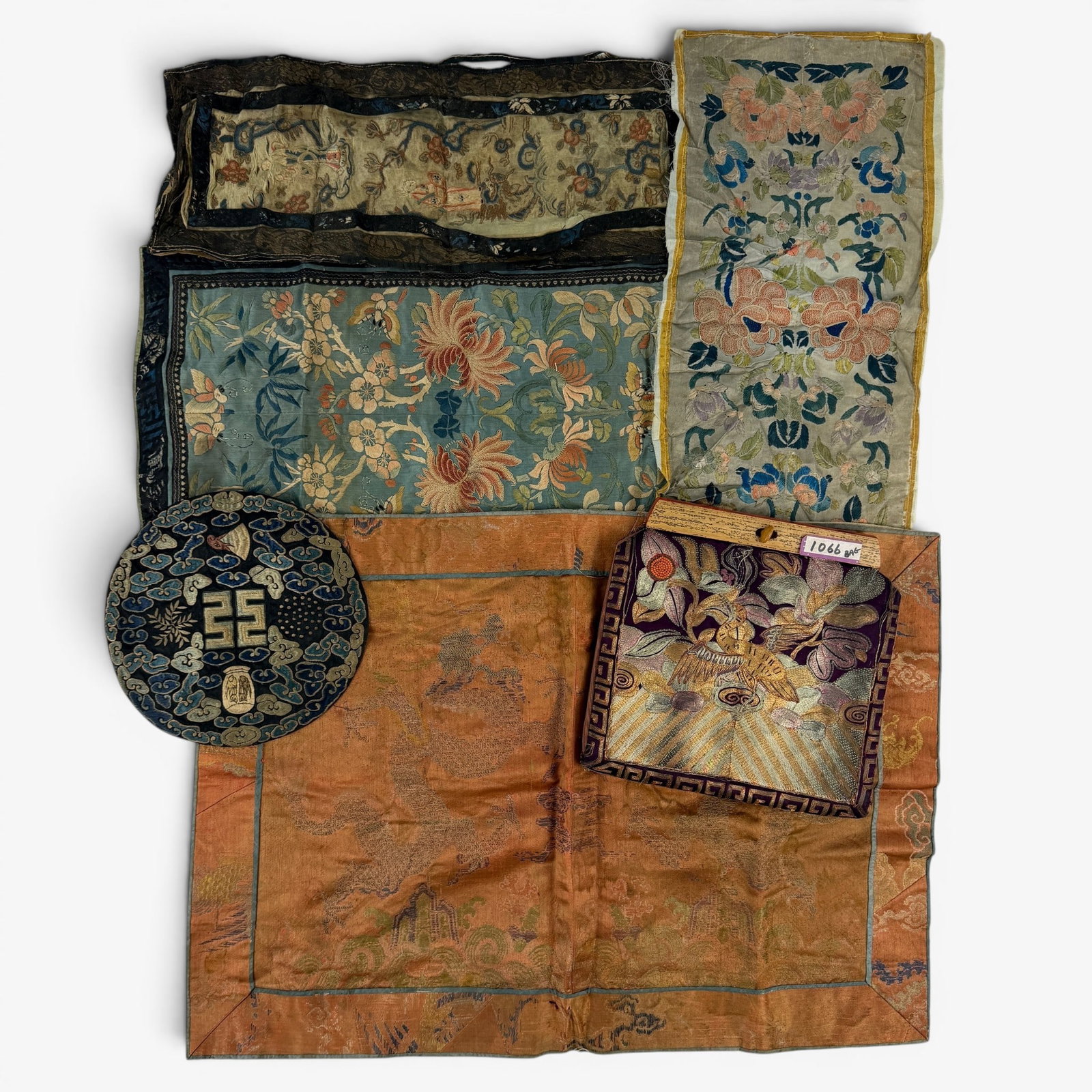 Collection of Chinese Textiles, 19th Century and Earlier: Including three panels with "forbidden" or "blind" stitch elements and embroidered floral subjects (Each in poor condition), as well as a pair of golden pheasant rank badges converted to a purse, one