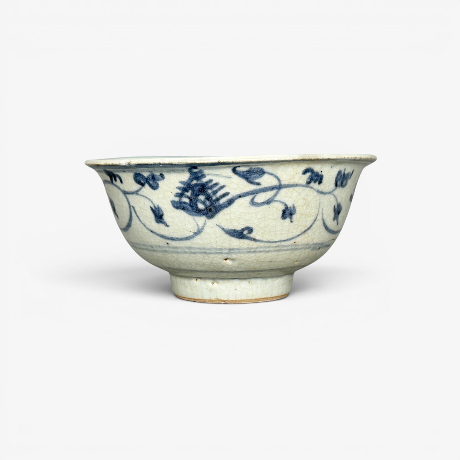 Ming Period Bowl wityh Spiky Blossoms: Ming period, a small blue underglaze decorated example, with collector note referencing Parke Bernet, a sale in 1974, the foot burnt to a light red. Ht. 2.5", diameter 5". PROVENANCE Private