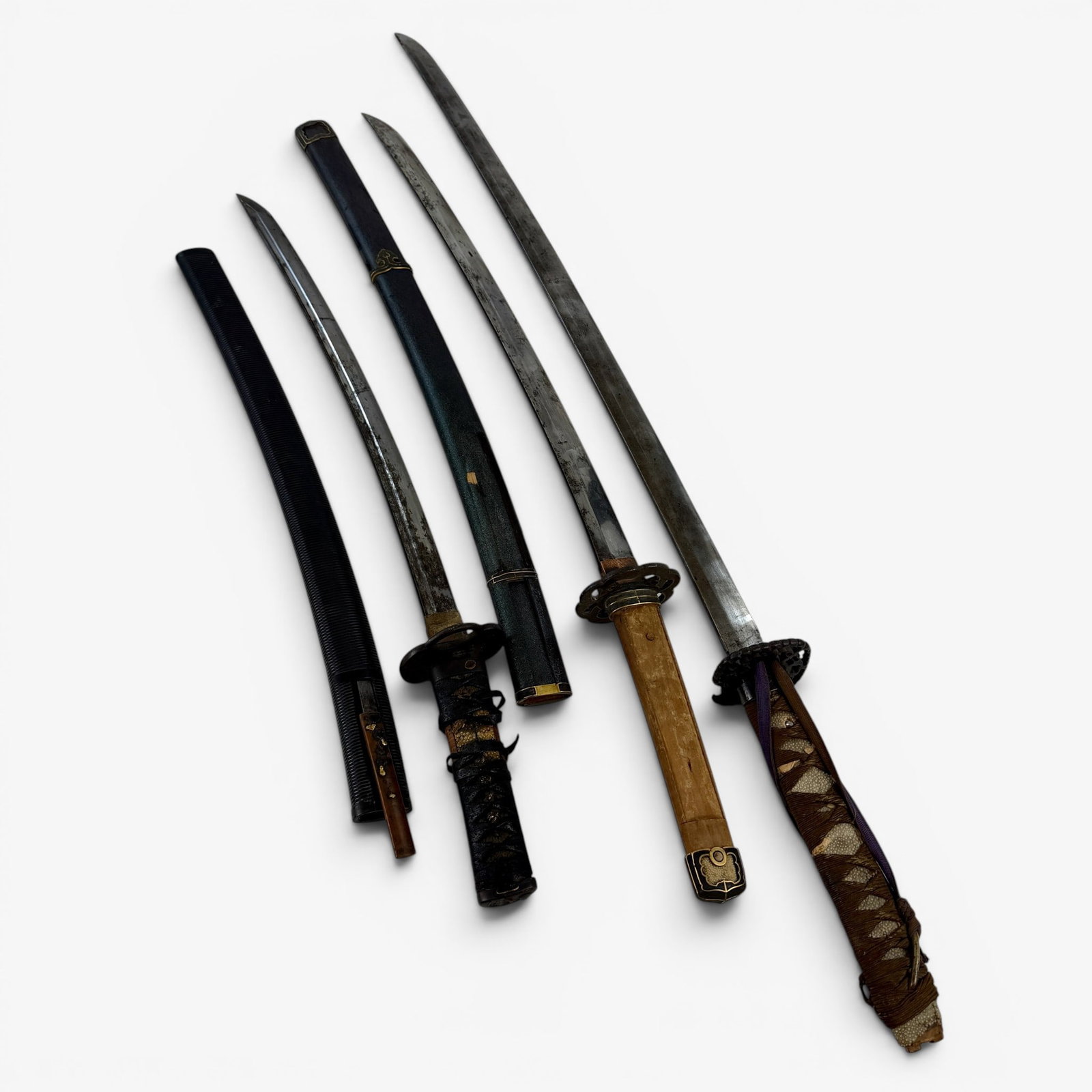 Three Japanese Swords: Including one 19th century example, with scabbard and mixed metal knife, and two other swords ca. 1900. Longest lg. 37".