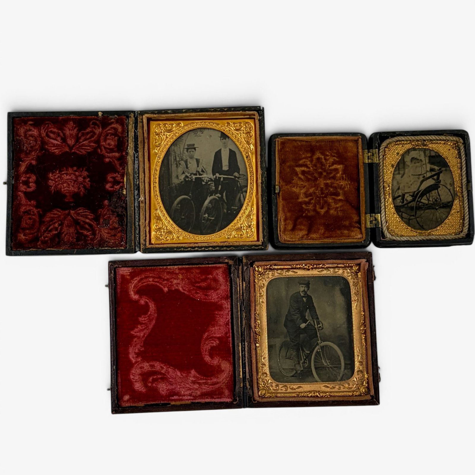 Three Tintypes with Bicycle Riders: All cased, including one husband and wife depicted with their cycles, a man atop his bicycle and a baby in a riding carriage.