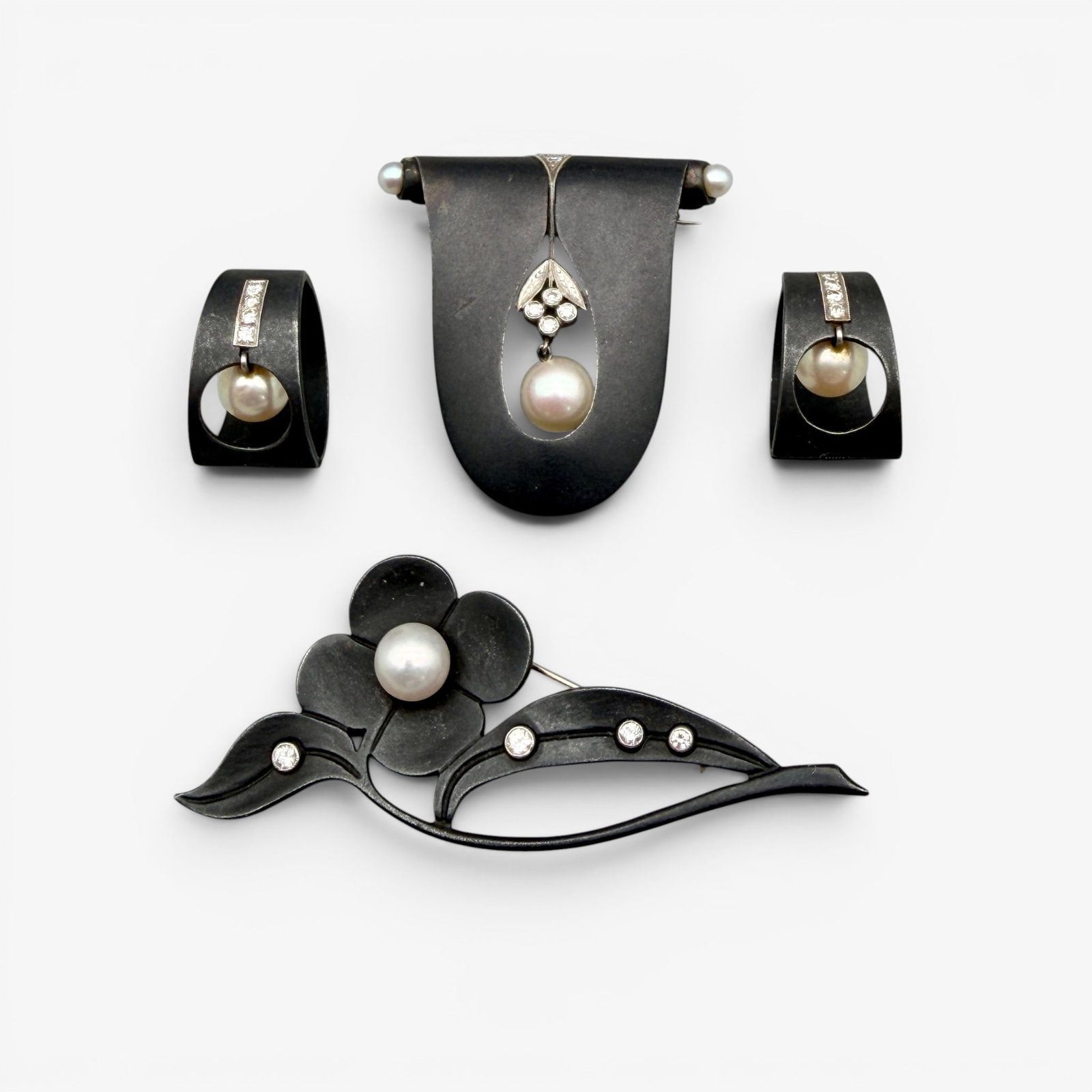 G.T. Marsh & SOns Diamond, Pearl and and Steel Jewelry Suite: G.T. Marsh & Sons, 20th century, consisting of a brooch, pair of earrings, and another pin, in oxidized steel, with cultured pearl and diamonds.