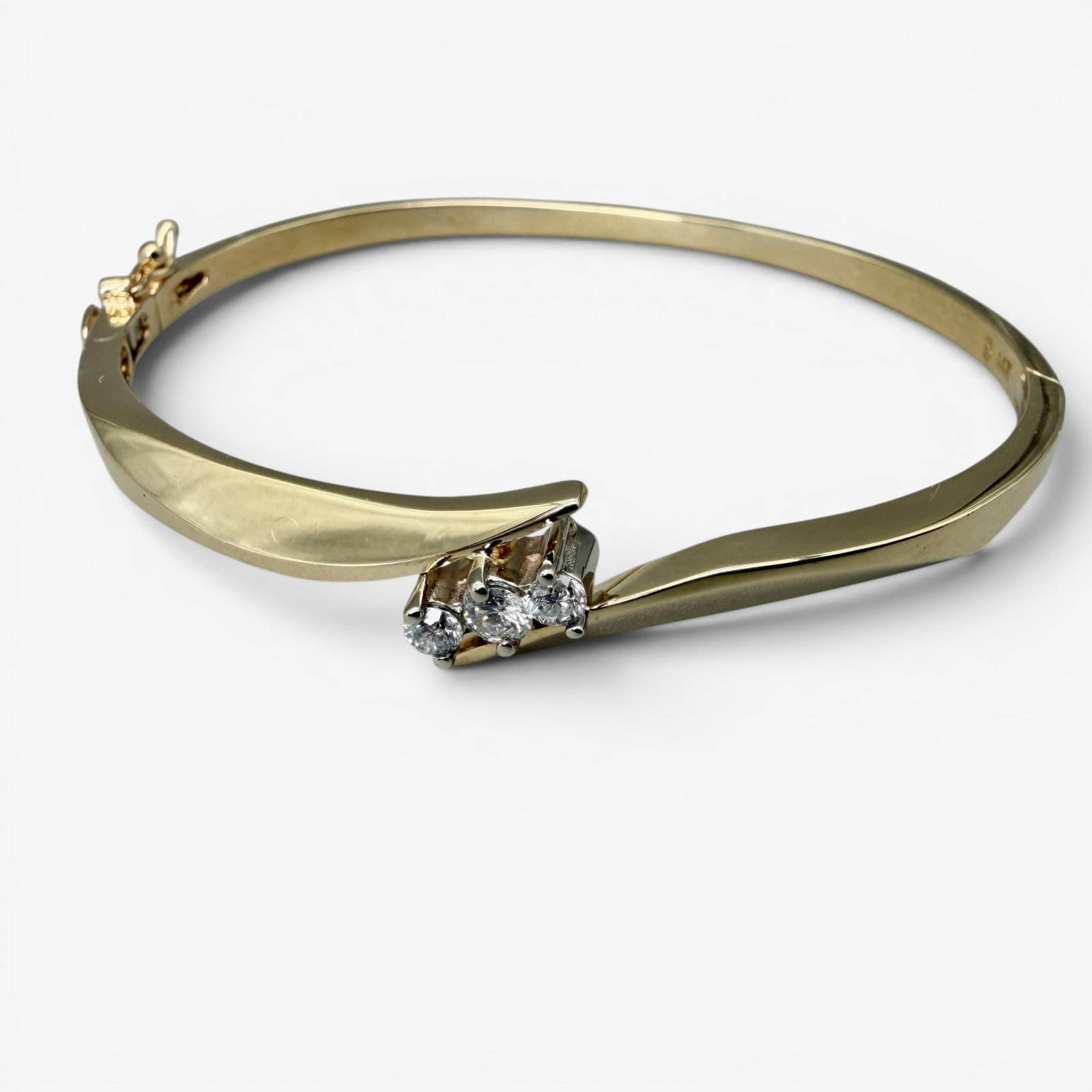 14K Yellow Gold and Diamond Bangle Bracelet: Containing three small inset diamonds, bracelet marked to interior for 14k gold. Total weight: .48 troy ounces