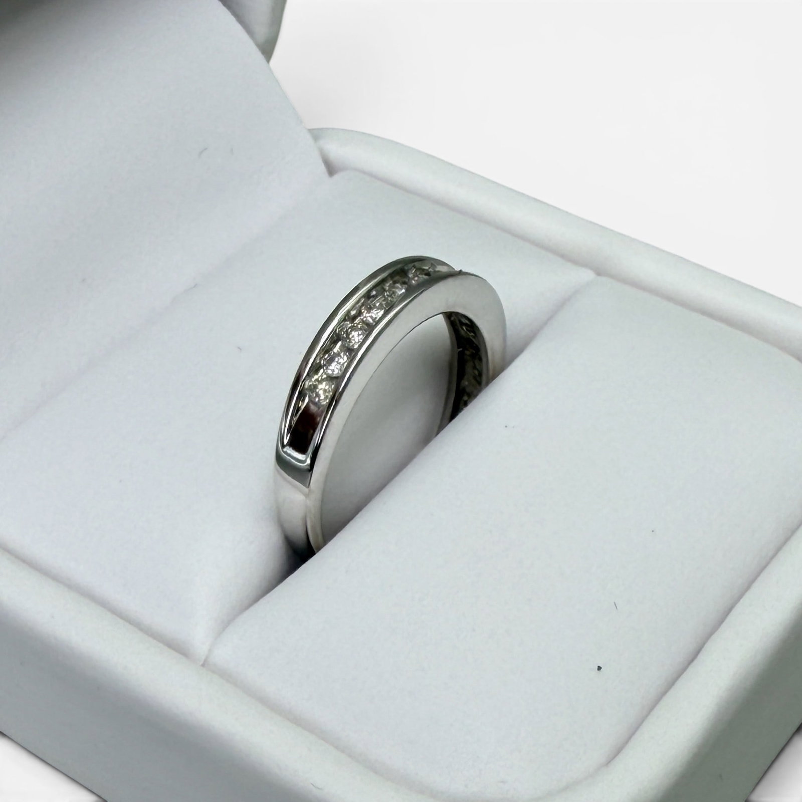 14K Gold Ring with Inset Diamonds: Including eleven total inset diamonds, marked for 14k gold. Total weight: .10 troy ounces