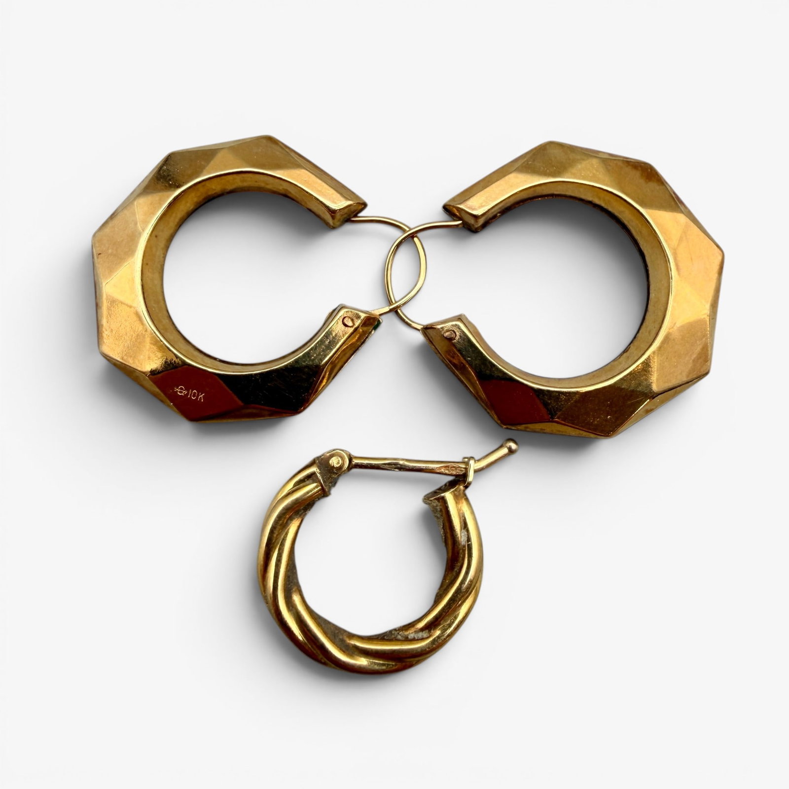 Group of 10k and 14k Earrings: A matching 10k gold hoop earring set and a single 14k gold hoop earring. Total weight: .12 troy ounces
