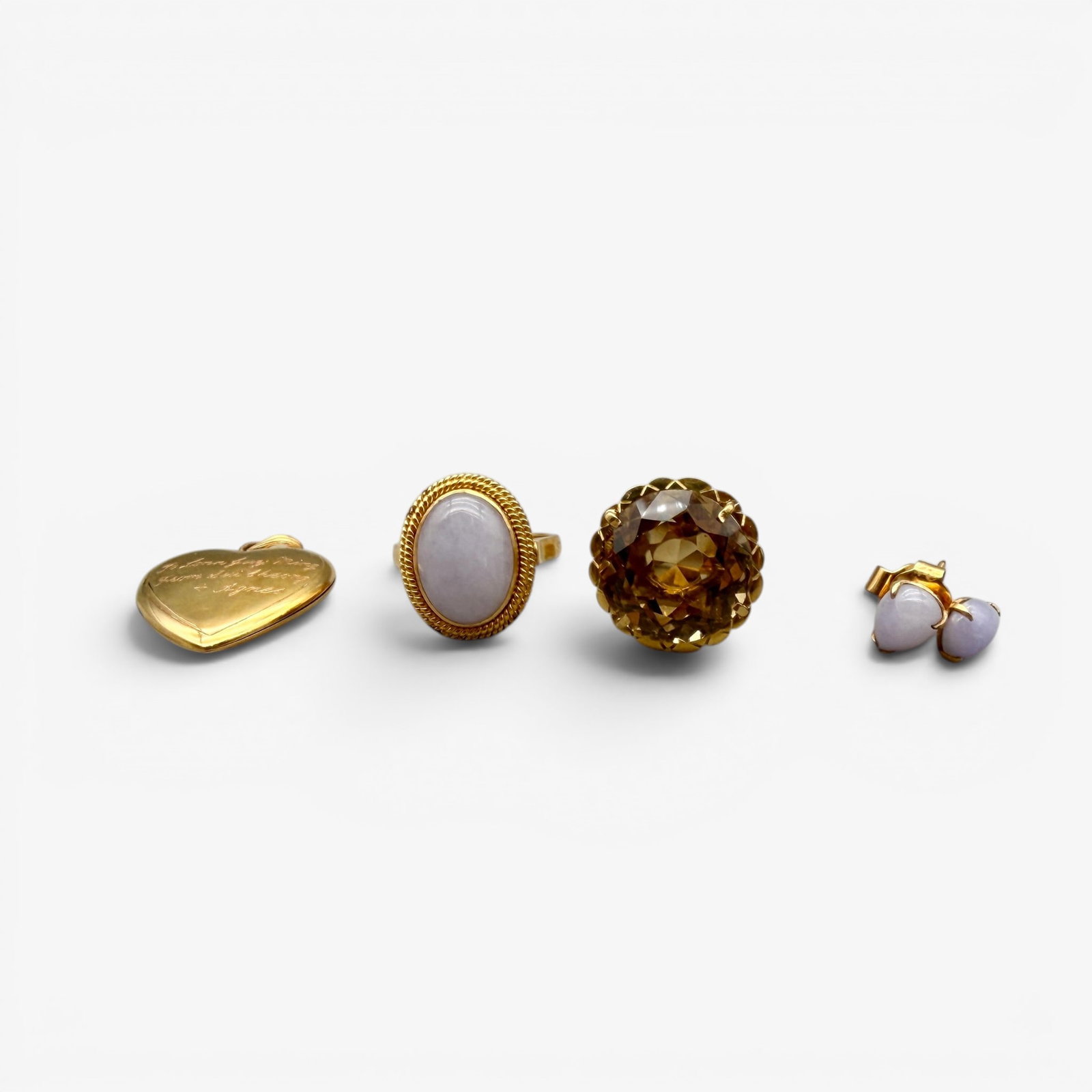 Group of 18K Gold Items: Including one engraved heart locket marked for 18k, one 18k gold ring and earring set with inset purple stones and lastly one 18k gold ring with large citrine. Total weight of all: .74 troy ounces