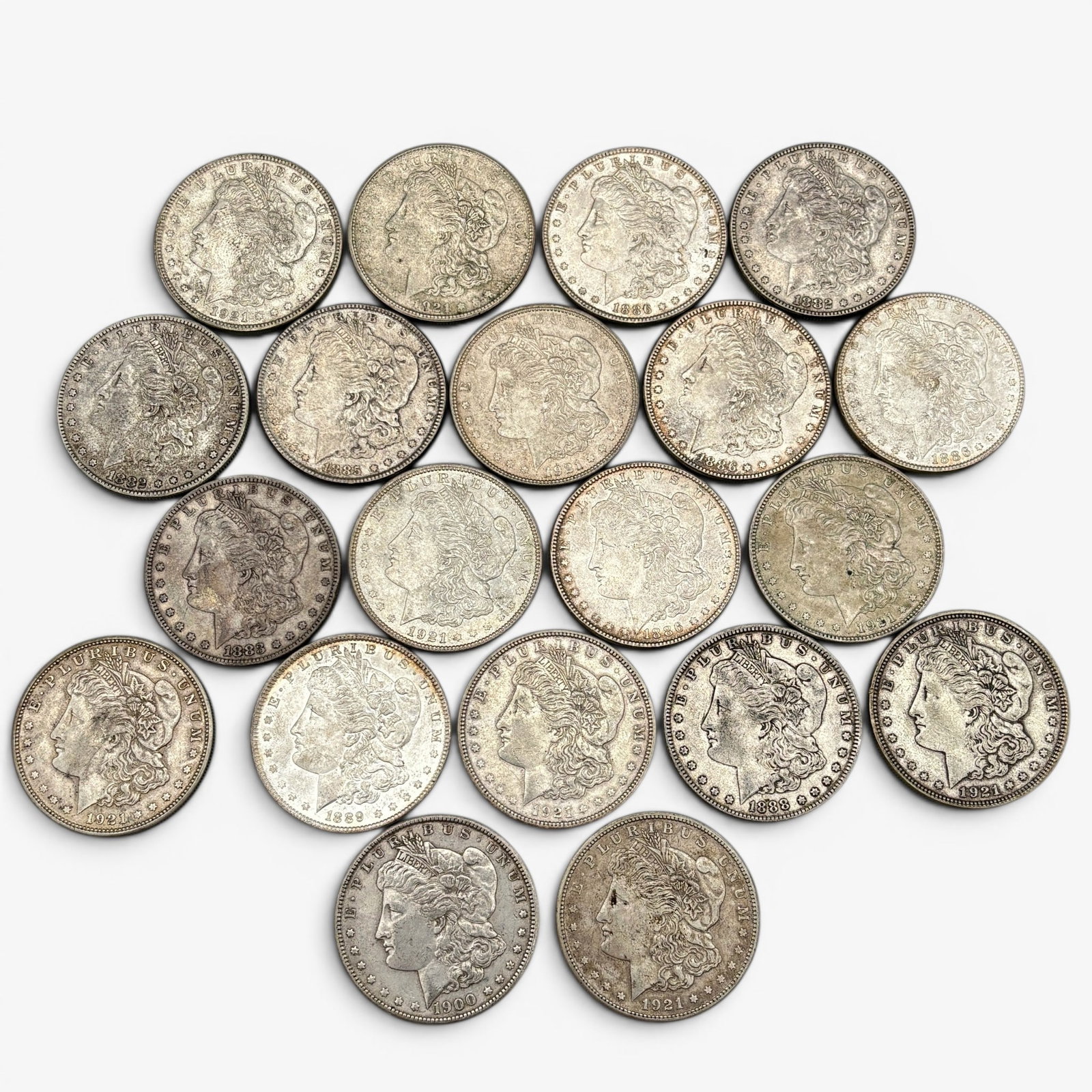Grouping of Twenty Morgan Silver Dollars: 20th and 19th century, multiple 1921 examples. Twenty silver dollars in total. All loose. 17.18 troy ounces.