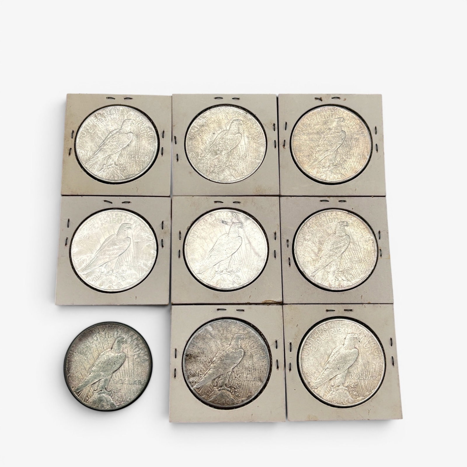 Group of Nine 1922 Peace Dollars: Nine in total, all housed in collectors sleeves. Varying states of condition.