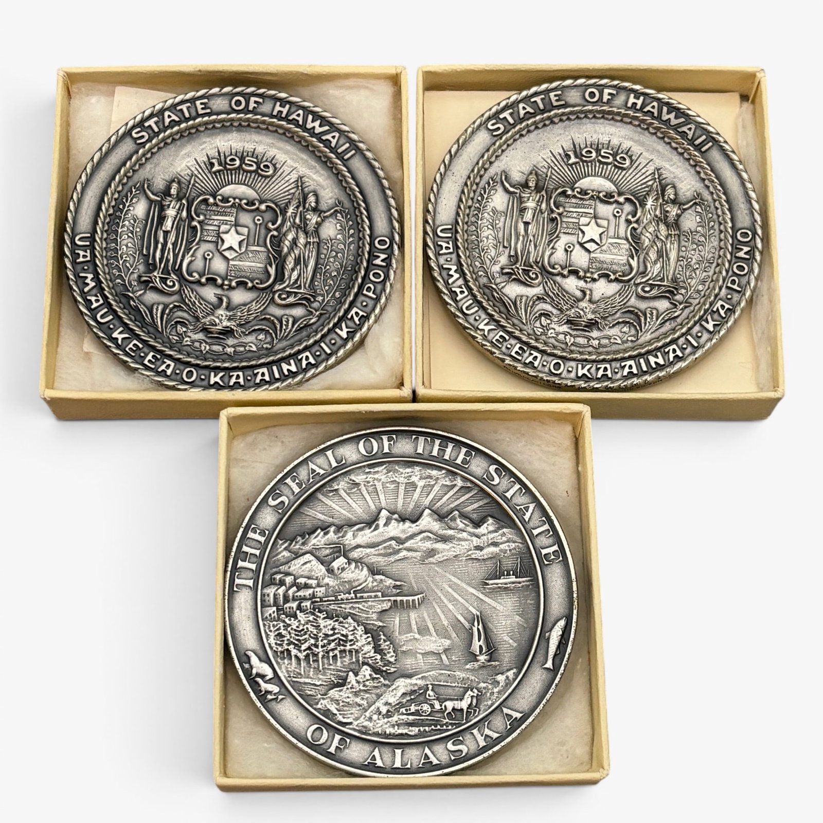 Three Commemorative Statehood Coins: Two commemorating the state of Hawaii, 1959 and one Alaska, also 1959. All housed in small cases