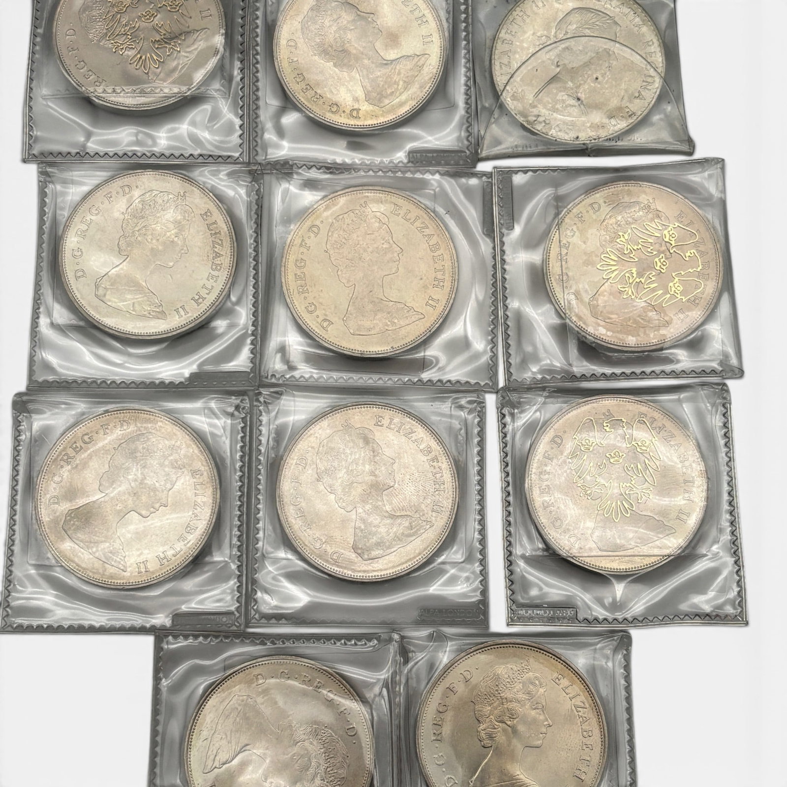Group of 11 Elizabeth II Silver Coins: Dates include 1981 (ten coins) and 1965 (one coin). All housed in plastic collectors sleeves
