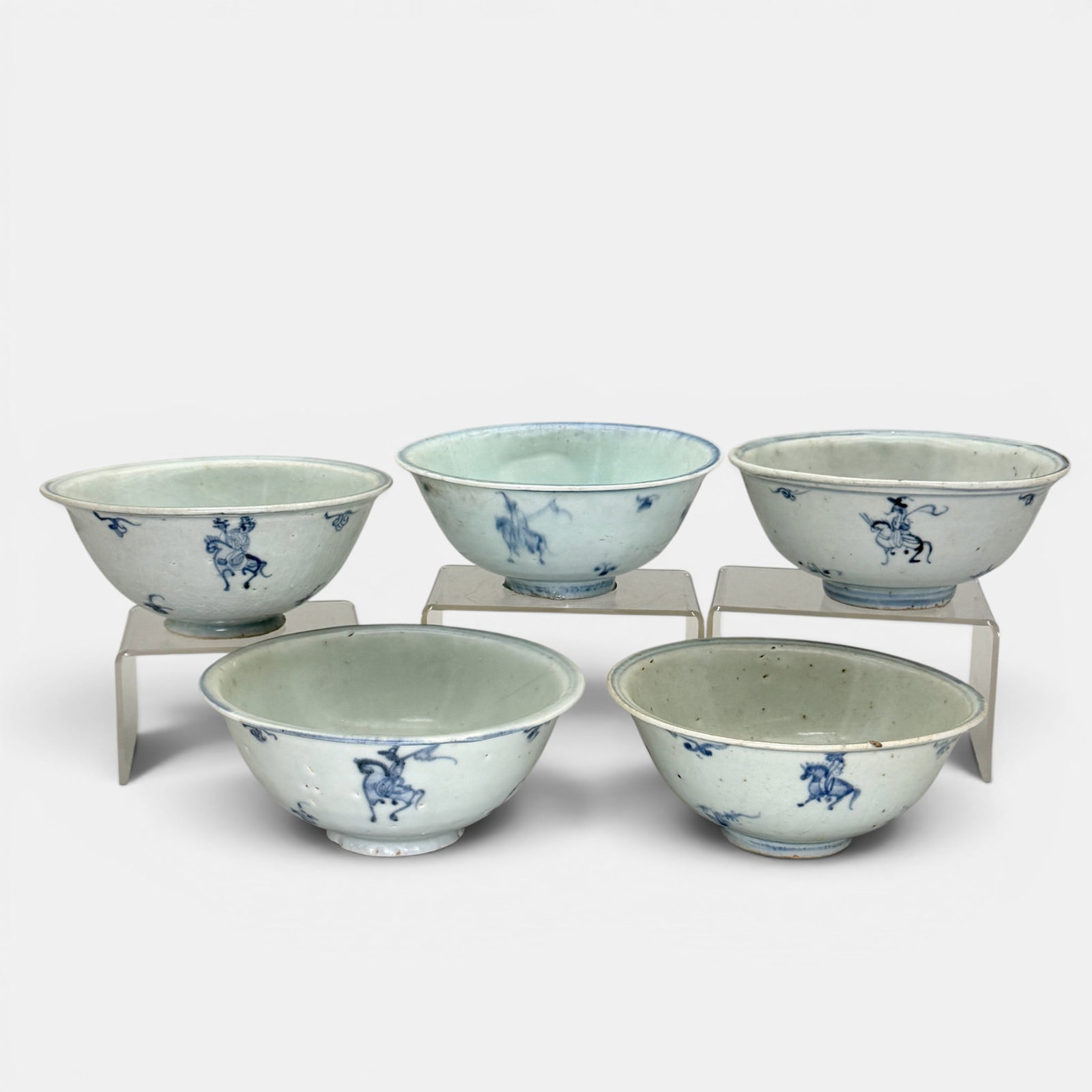 Five Blue and White Bowls, Ming: Ming dynasty, a group of 5 bowls, each with similar blue underglaze design, with repeated figure on horse. Each approximately 2.75" ht., 5.75" diameter.