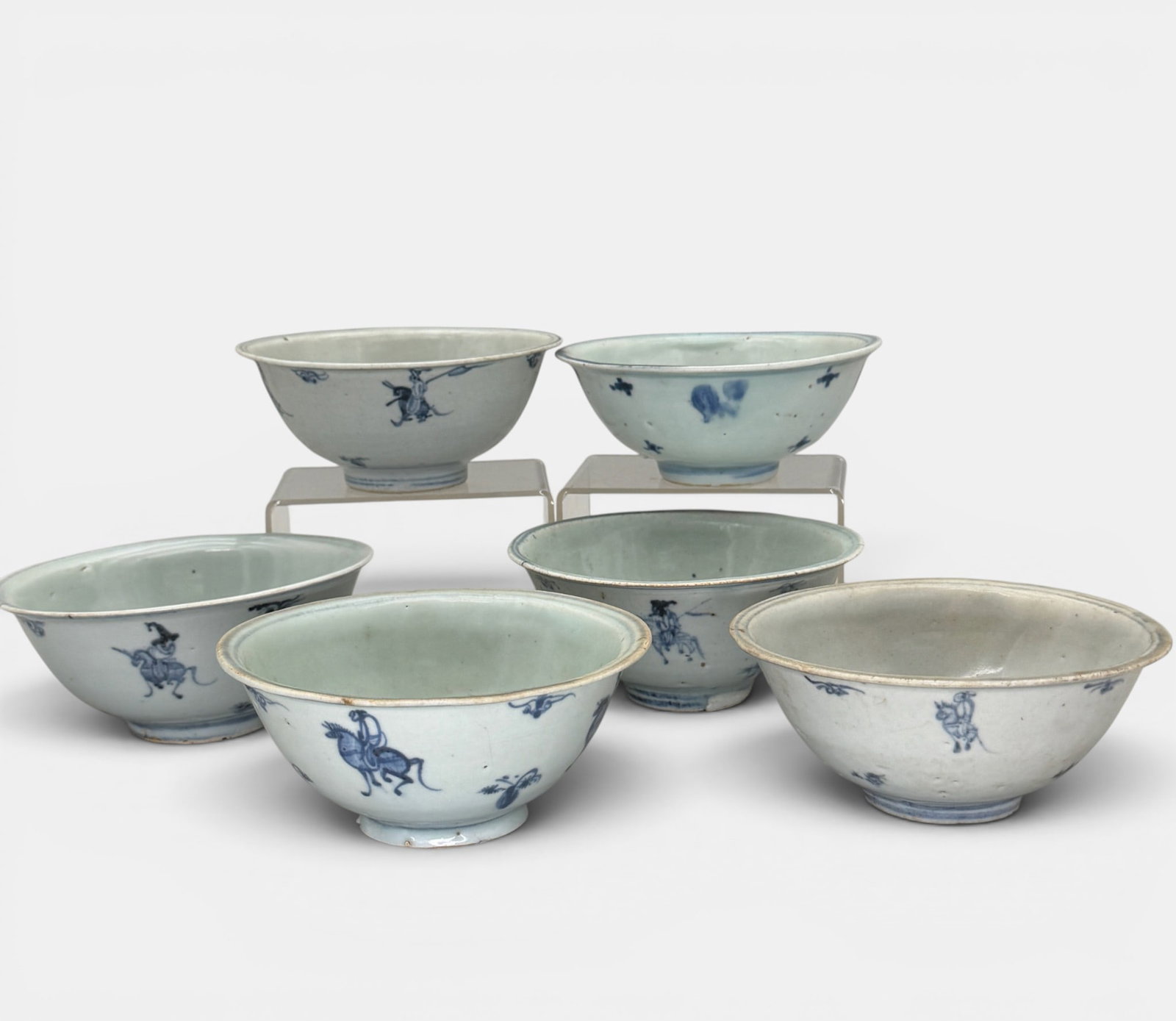 Six Blue and White Bowls, Ming: Ming dynasty, a group of 6 bowls, each with similar blue underglaze design, with repeated figure on horse. Each approximately 2.75" ht., 5.75" diameter.