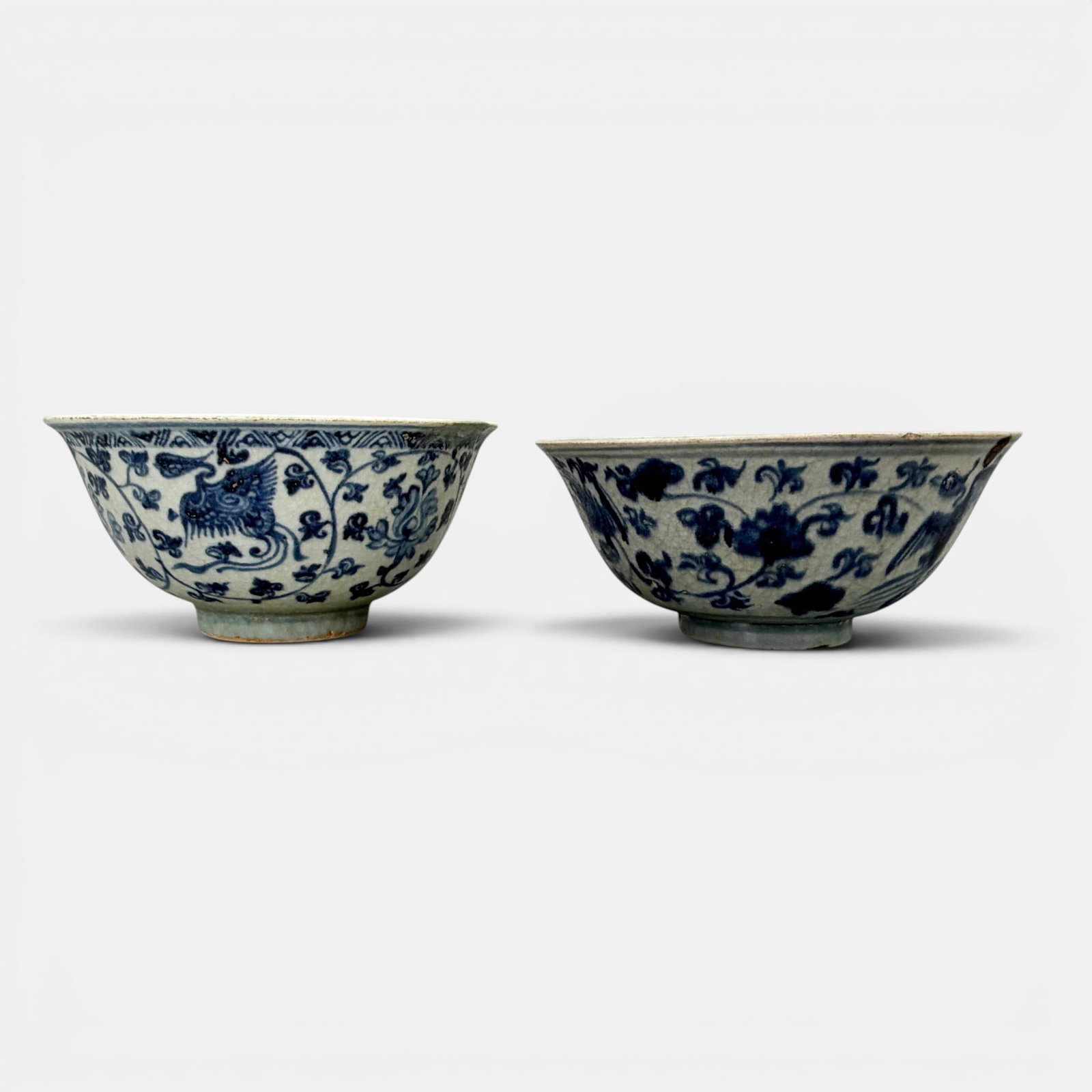 Pair of Ming Blue and White Phoenix Bowls: Each Ming dynasty, with blue underglaze phoenix decoration to exteriors. Largest ht. 2.75", diameter 6.25".