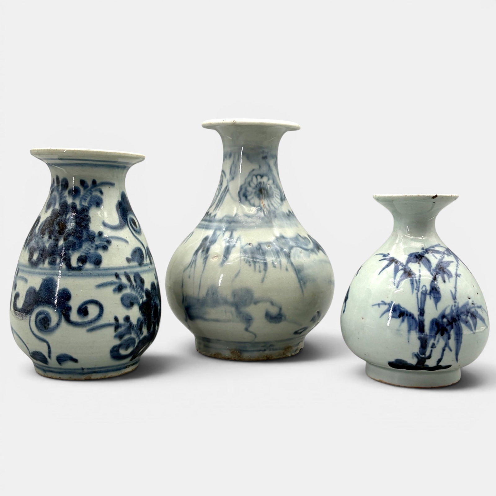 Three Ming Blue and White Vases: Each late Ming, including one with bamboo design, one mountainout, and another floral. Tallest ht. 8".