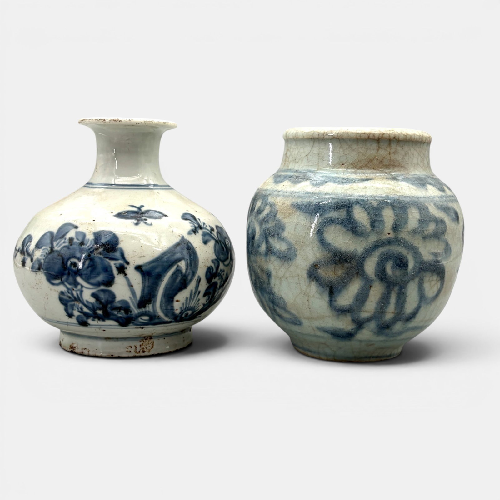 Pair of Ming Blue and White Vases: Each Ming, each with floral exterior design, one with clay burnt to a dark brown to underside. Tallest ht. 6".