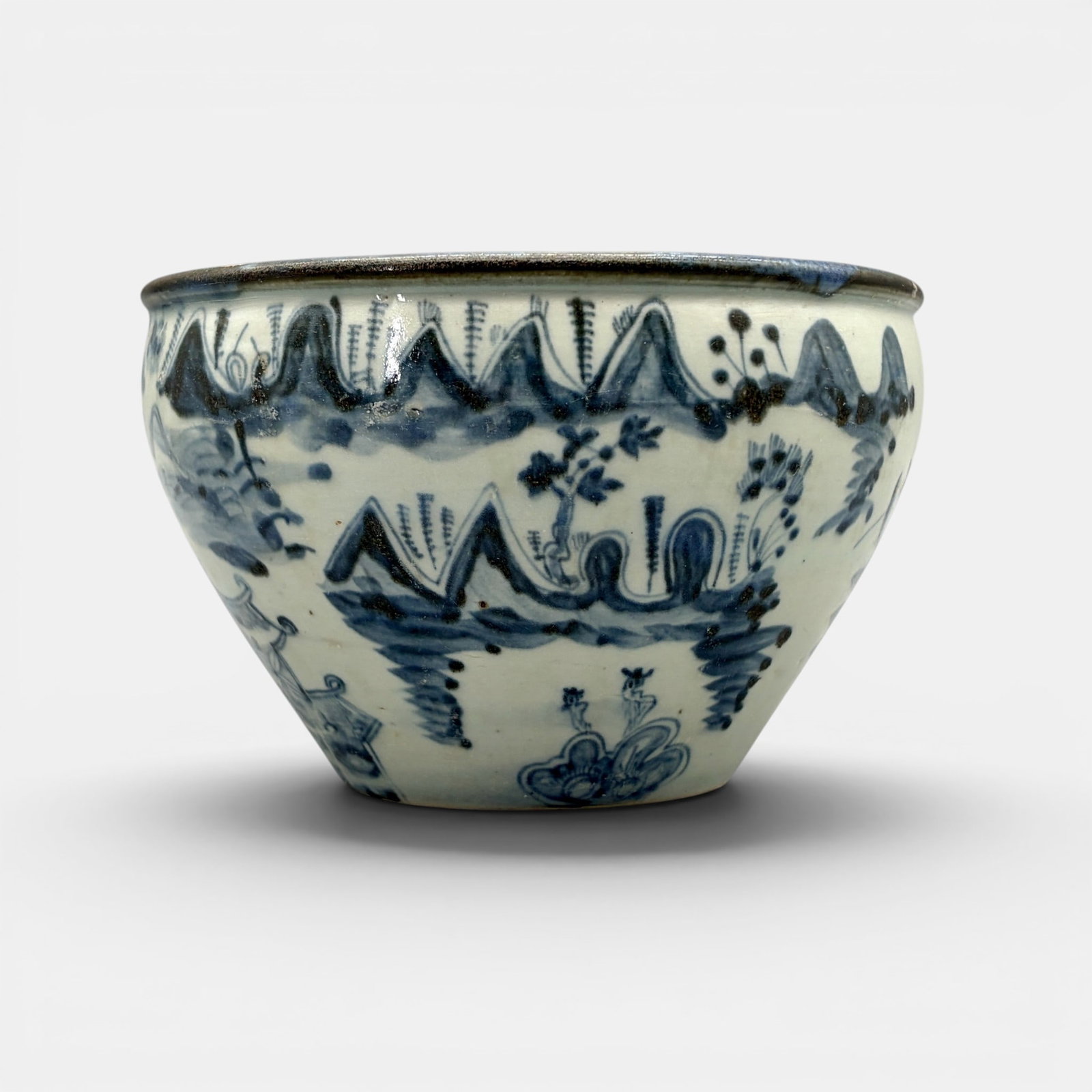 Ming Blue and White Planter: A small flaring planter, with landscape decoration, late Ming. Unusual rim with bleeding cobalt and dark glaze cover. Ht. 4".