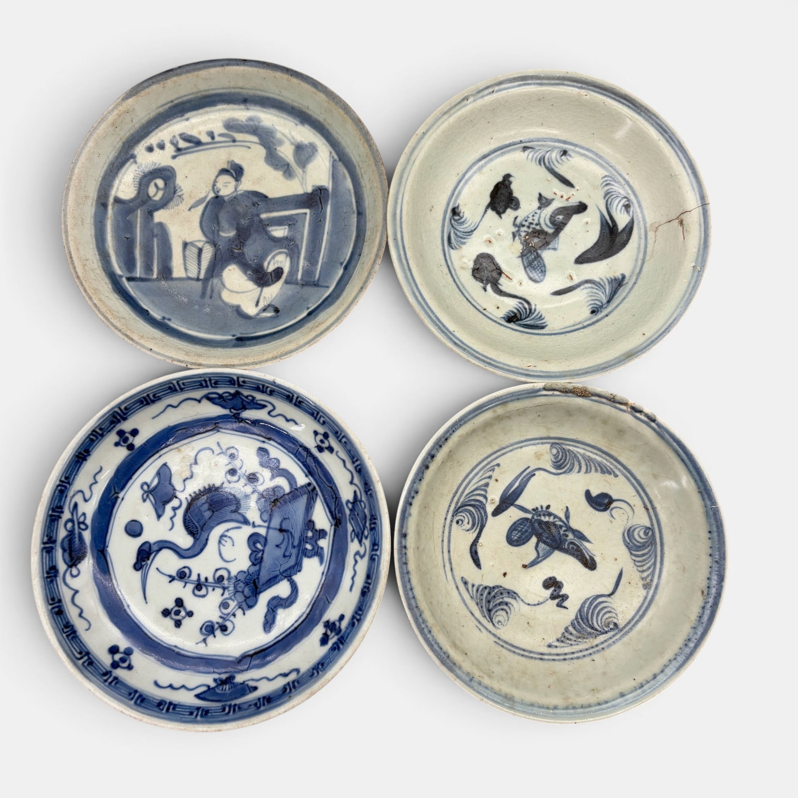 Four Ming Blue and White Dishes: A pair of which contain shell and fish design. Largest diameter: 7"