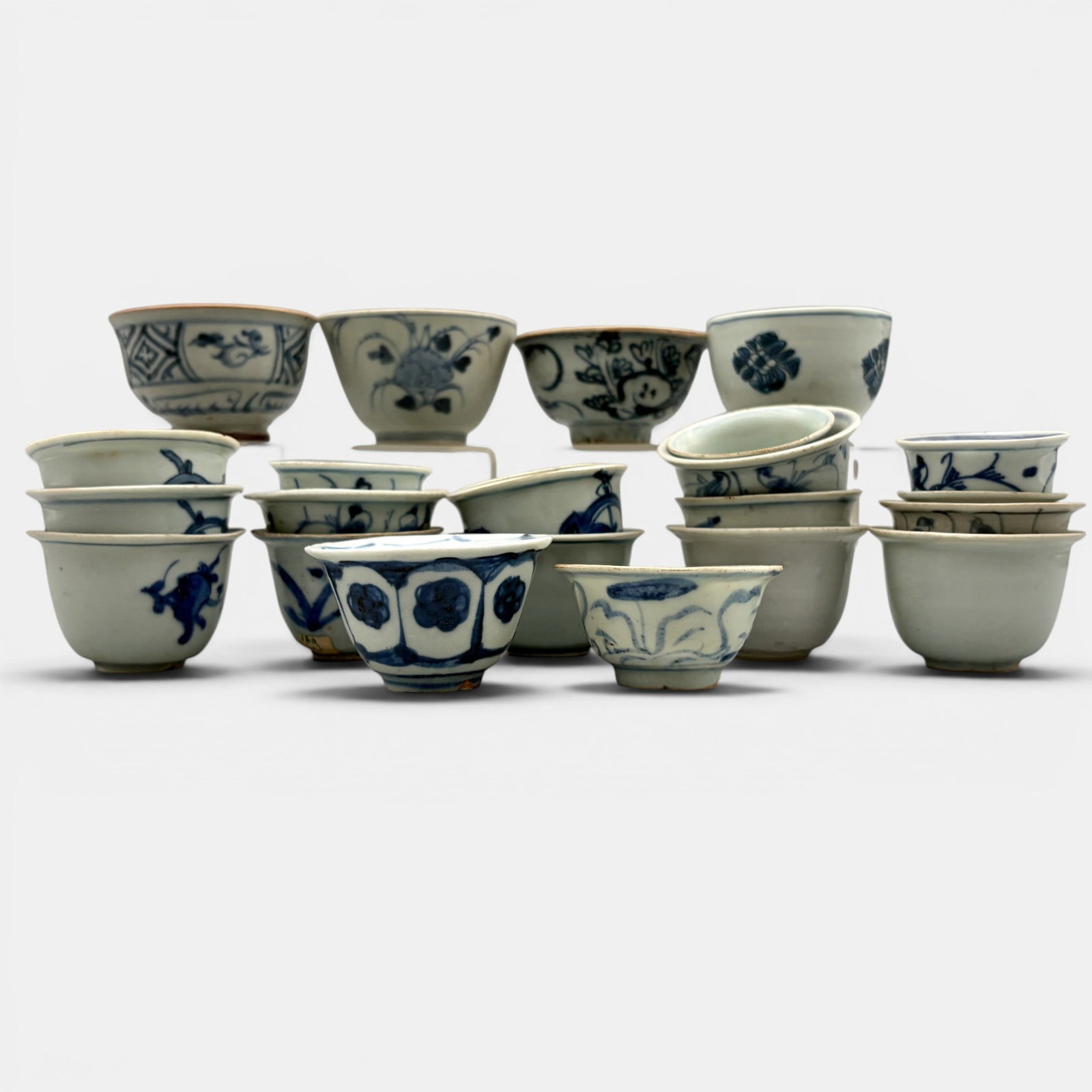 Group of 21 Ming Period Blue and White Teacups: 21 examples in total. All ming, several with beast design to exterior. Others have plain white glaze. Tallest height: 2"
