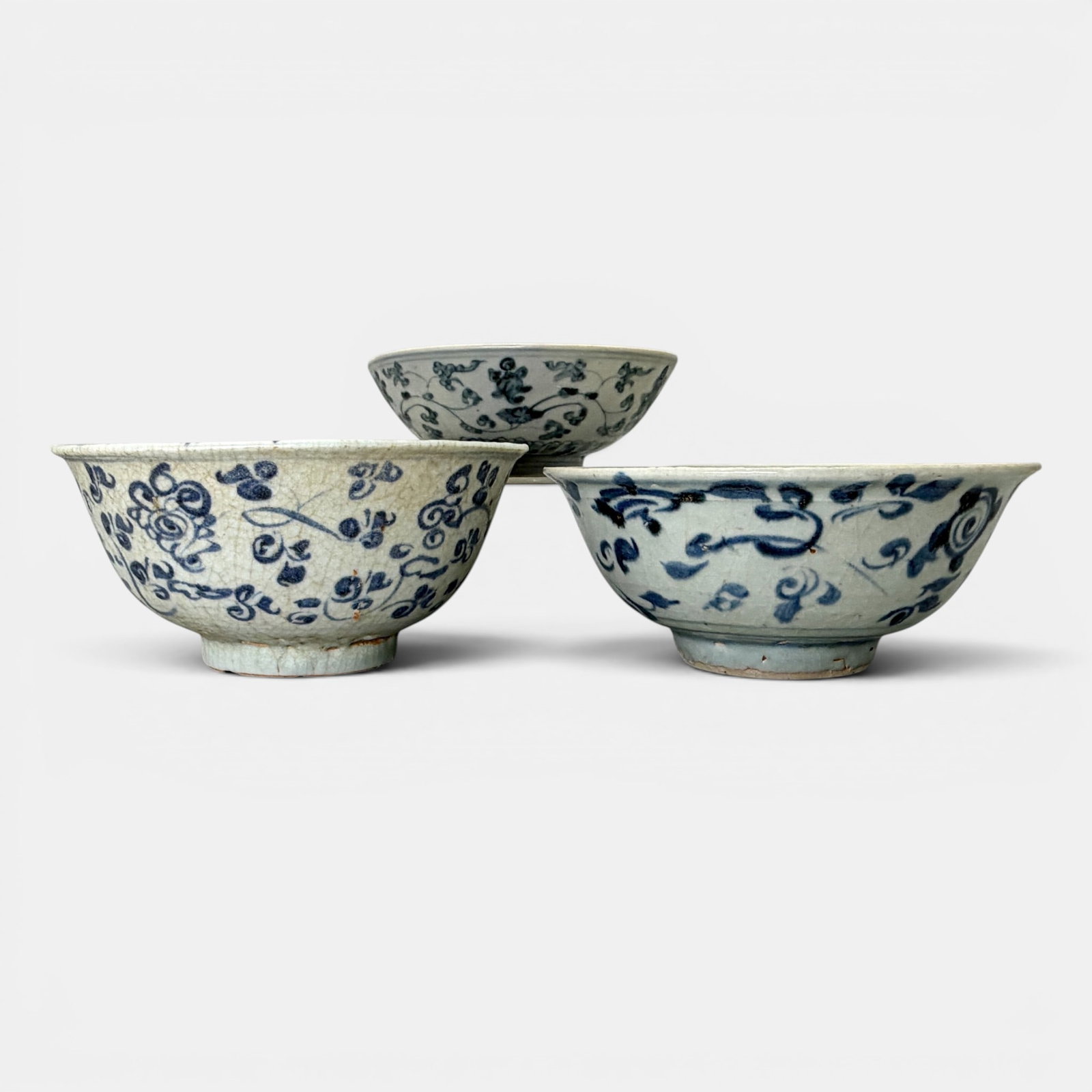 Three Ming Blue and White Bowls: One with a more muted cobalt, each with flowing foliage in underglaze blue. Largest ht. 2.75", diameter 6".