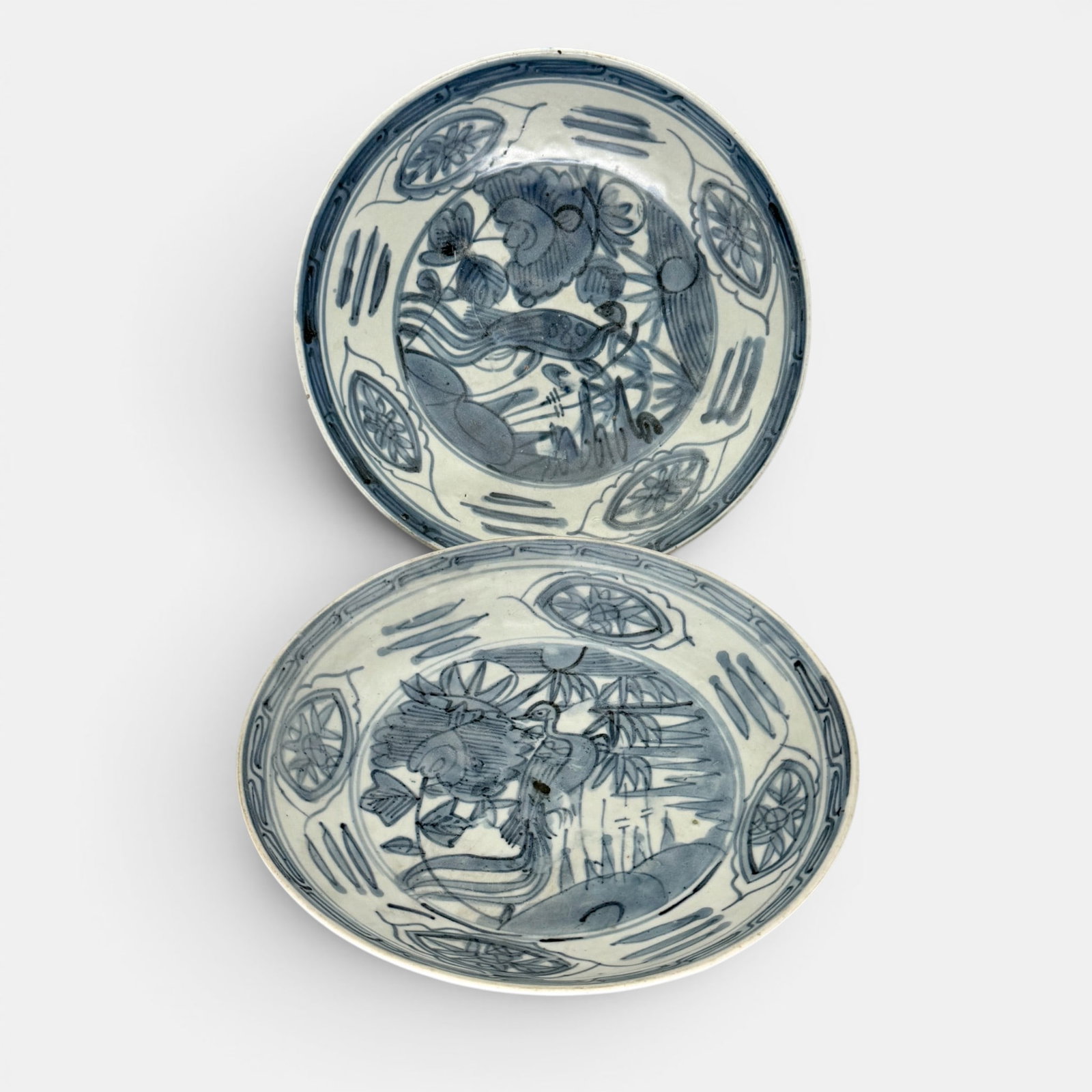 Pair of Chinese Ming Swatow Type Dishes: Ming period, a pair of swatow type blue and white dishes, each with central bird and scrollwork borders. Each diameter 9.75".