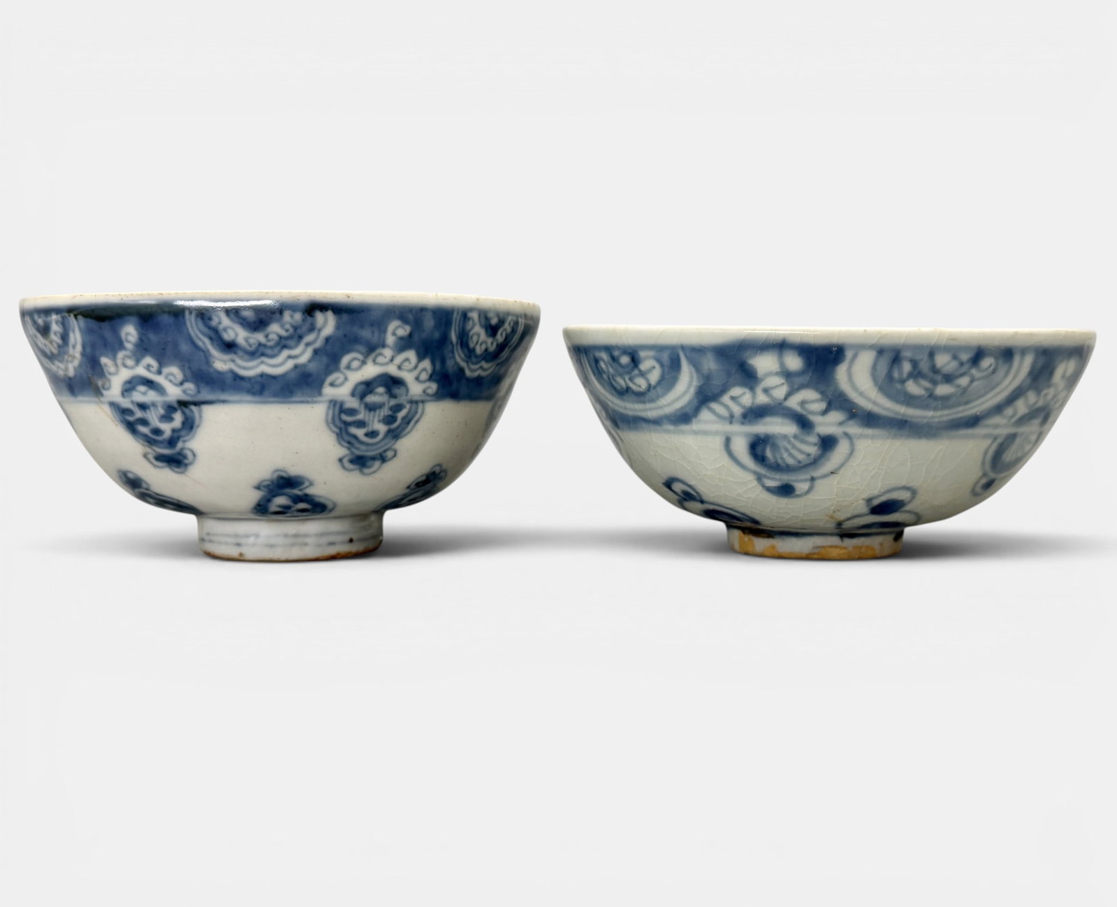 Pair of Ming Blue and White Bowls: Ming dynasty, both with very similar decoration to exterior, possibly from the same shop. Lined blue interiors. One heavily crazed and one uncrazed. Diameter of largest: 5.75"
