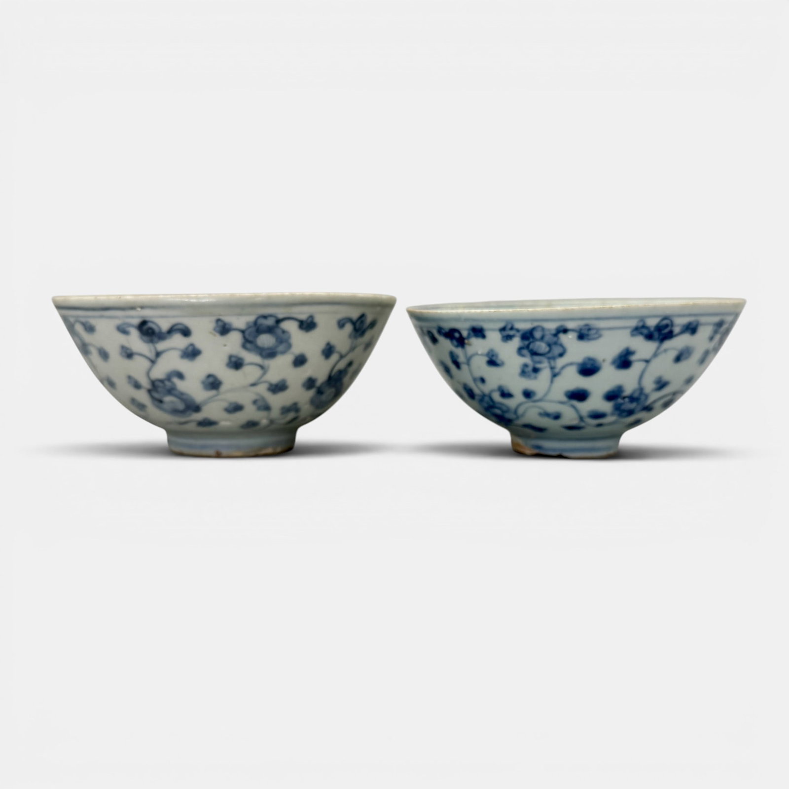 Pair of Ming Blue and White Bowls: A pair of smaller Ming bowls, each with flower and vine to exterior body. Tallest ht. 2.25", diameter 5".