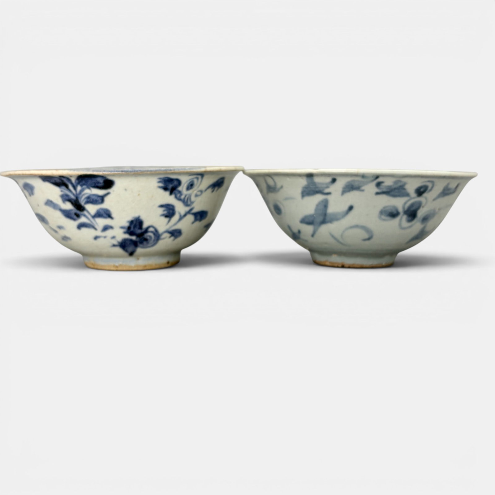 Pair of Ming Blue and White Bowls: Each early Ming, with sparse floral decoration to body of each. Each 2.5" ht., 5.75" diameter.