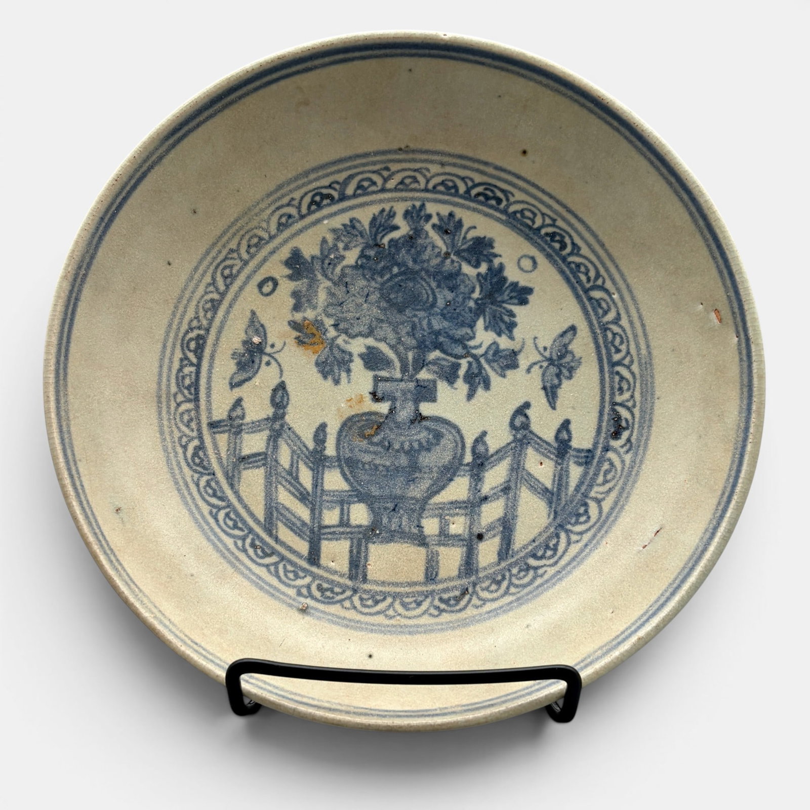 Ming Blue and White Dish: A dish with central interior decoration of a vase in a fenced area, the exterior body with foliage. Diameter 8".