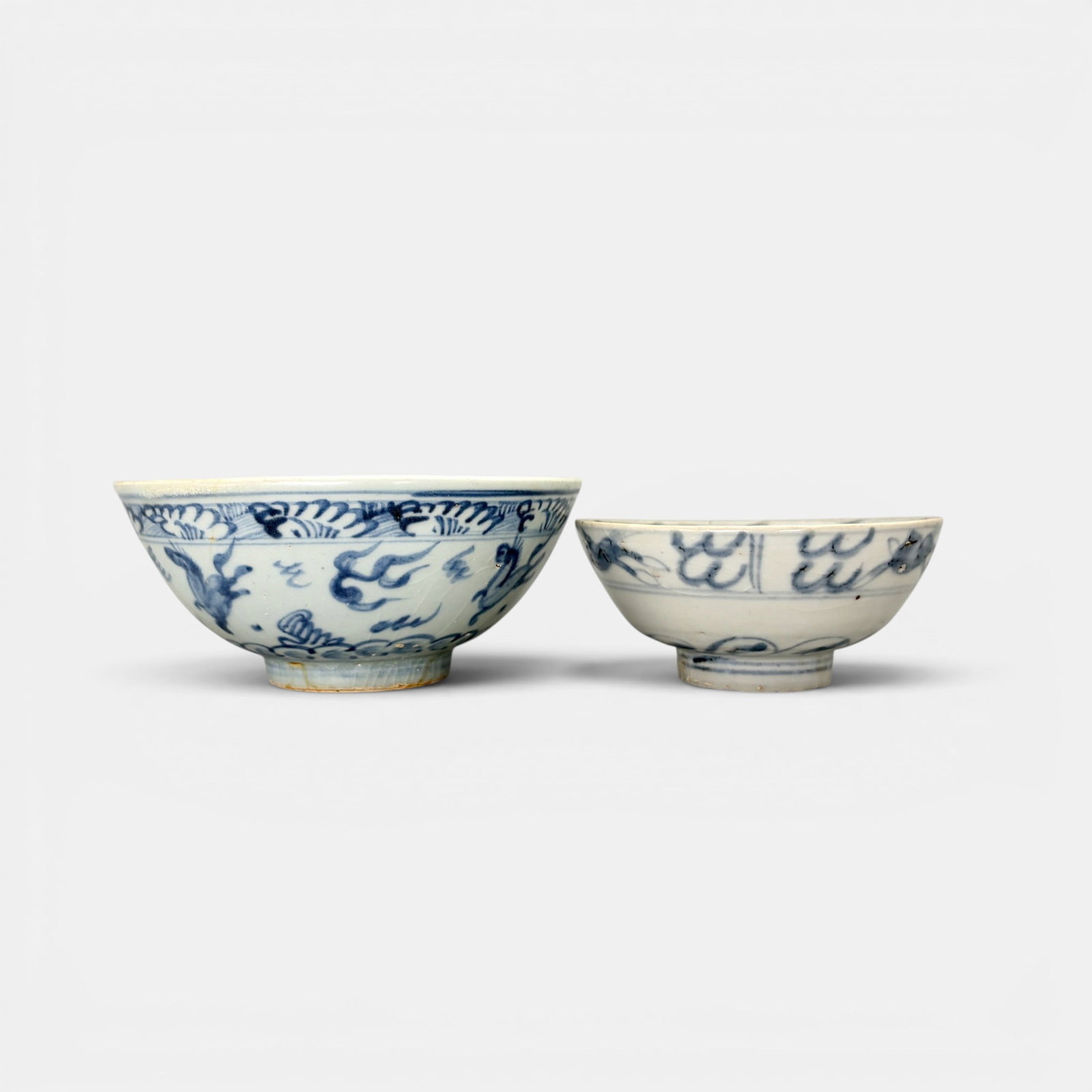 Pair of Ming Blue and White Bowls, Galloping Horses: Each with galloping horse motif, the small example near the rim. Ht. of tallest 2.5", diameter 5.75".