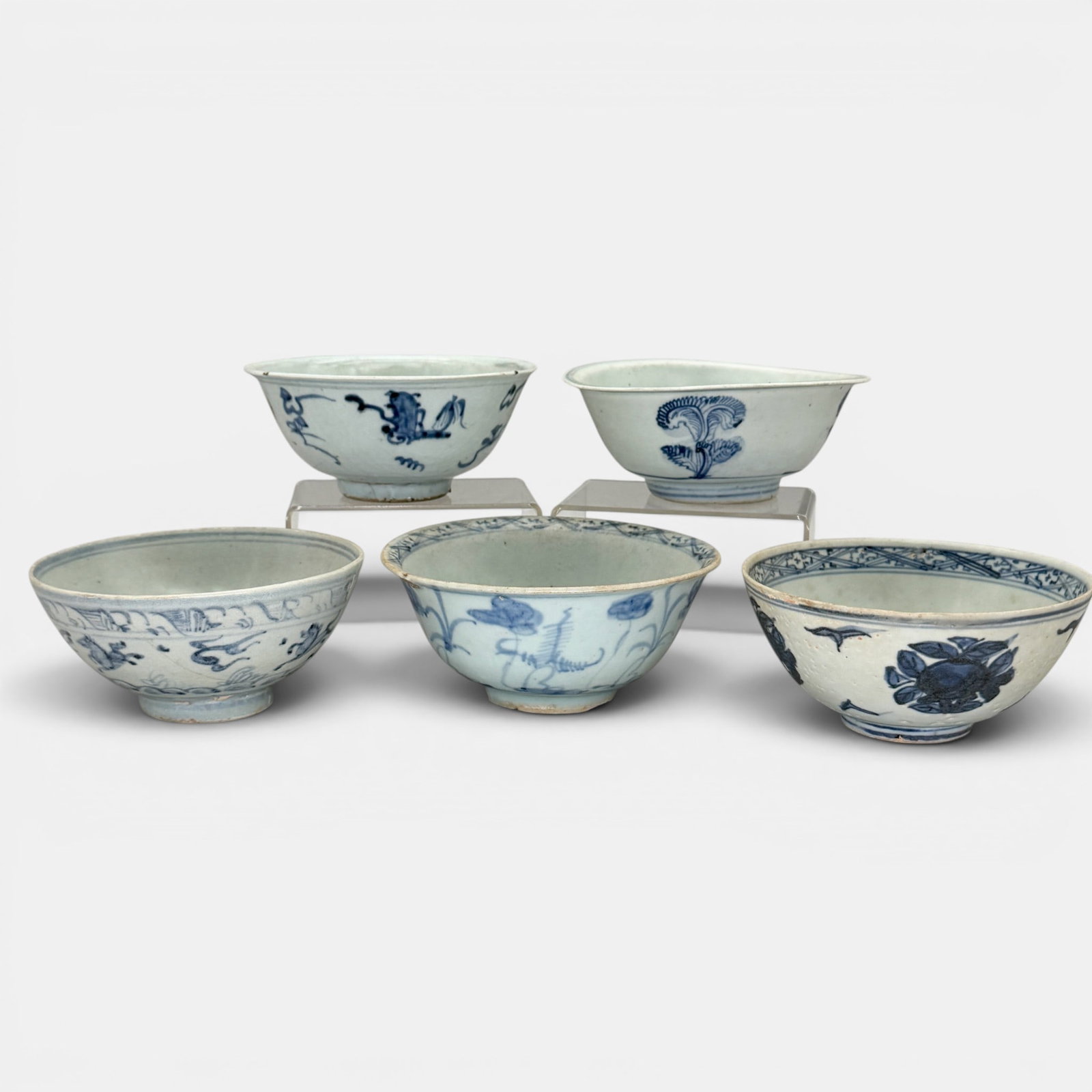 Group of 5 Blue and White Ming Bowls: Varying underglaze blue designs. Largest ht. 2.5", diameter 6.25".