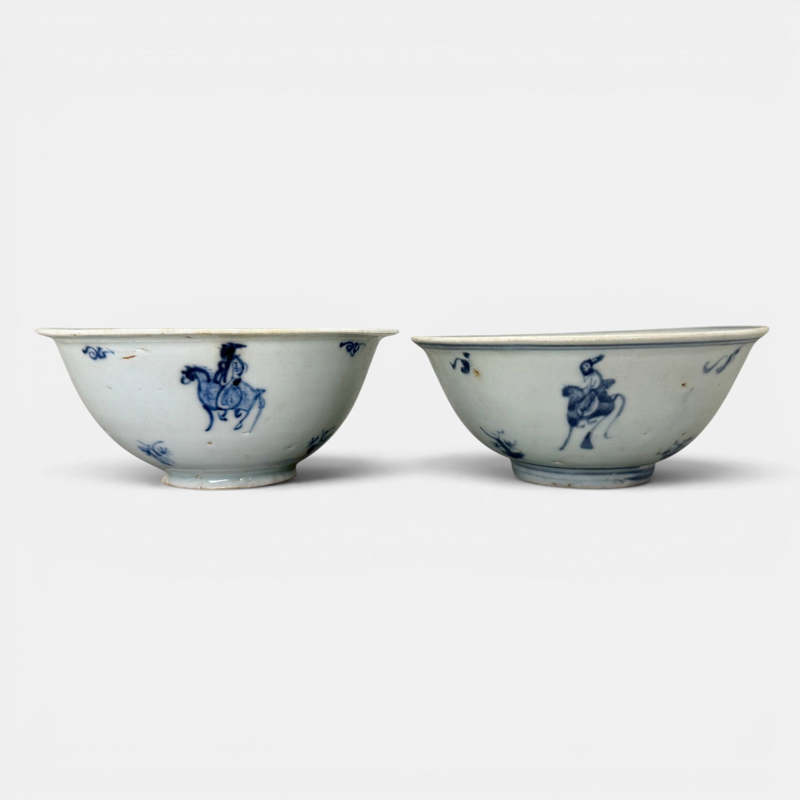 Pair of Ming Blue and White Bowls: A pair with sparsely decorated figures on horseback. Largest ht. 2.5", diameter 6".