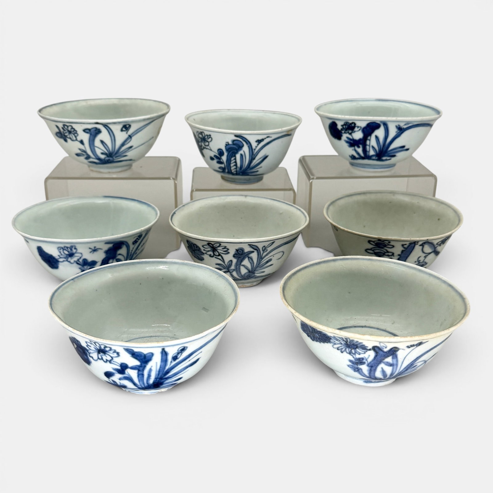 Group of 8 Ming Blue and White Bowls: Each with single floral design to body, and interior in the round. Largest ht. 2.5", diameter 5".