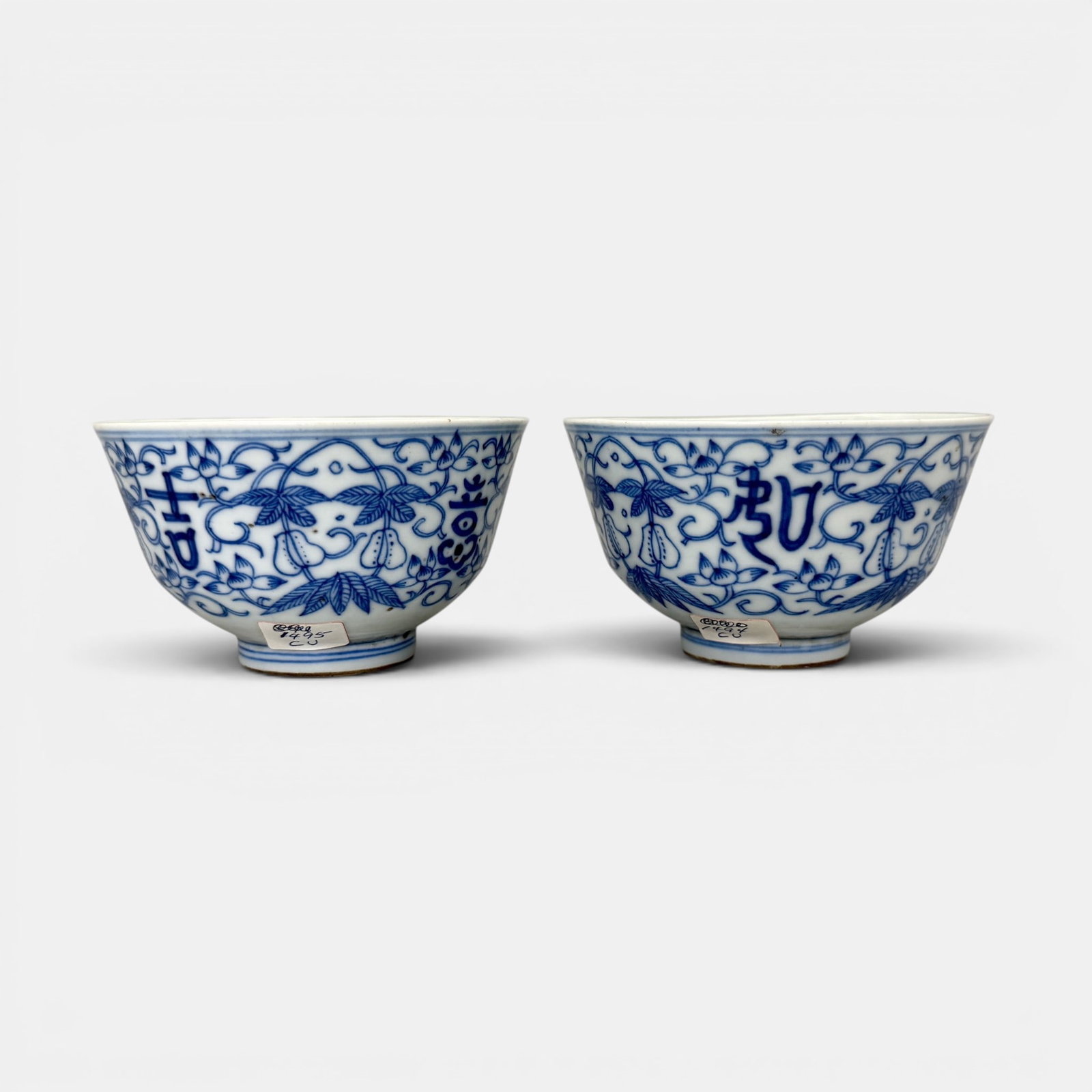 Pair of Late Ming Blue and White Cups: A pair of teacups, with heavily petterned blue underglaze decoration, auspicious mark to underside of each. Each ht. 2.25".