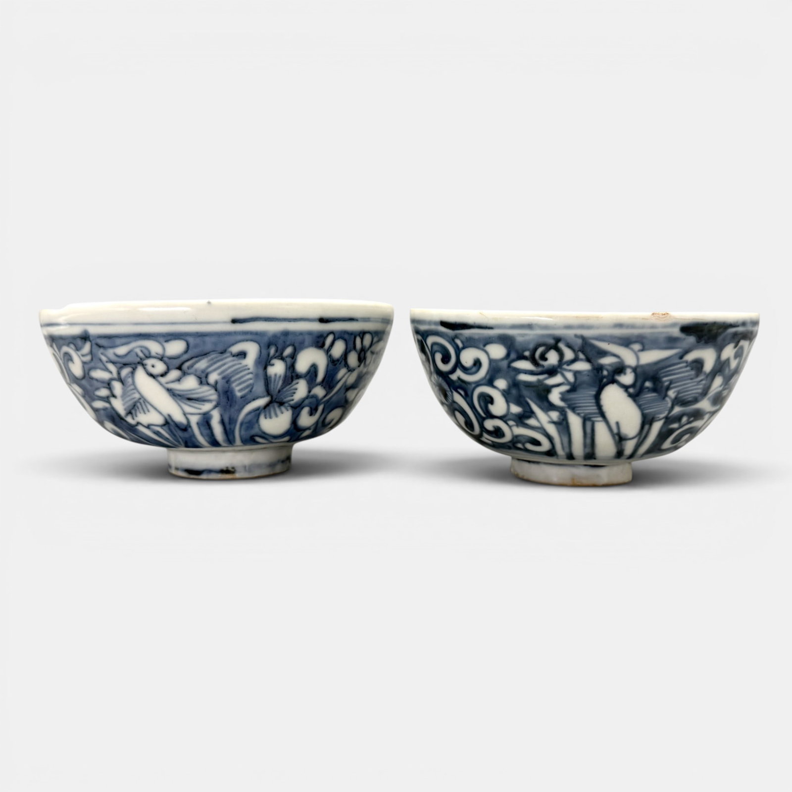 Pair of Ming Blue and White Decorated Bowls: Both Ming, both decorated in similar fashion with floral and bird motif to exterior. Largest diameter: 6"