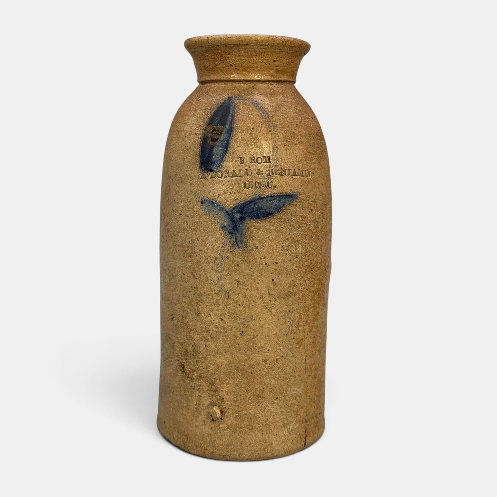 Storage jar with cobalt flower, McDonald and Benjamin, Cin. O.: Buff colored storage jar with cobalt flower decoration. Impressed "From McDonald & Benjamin Cin.O." on the shoulder. Height 10 3/8 inches. From the Jerry Stehlin Collection.