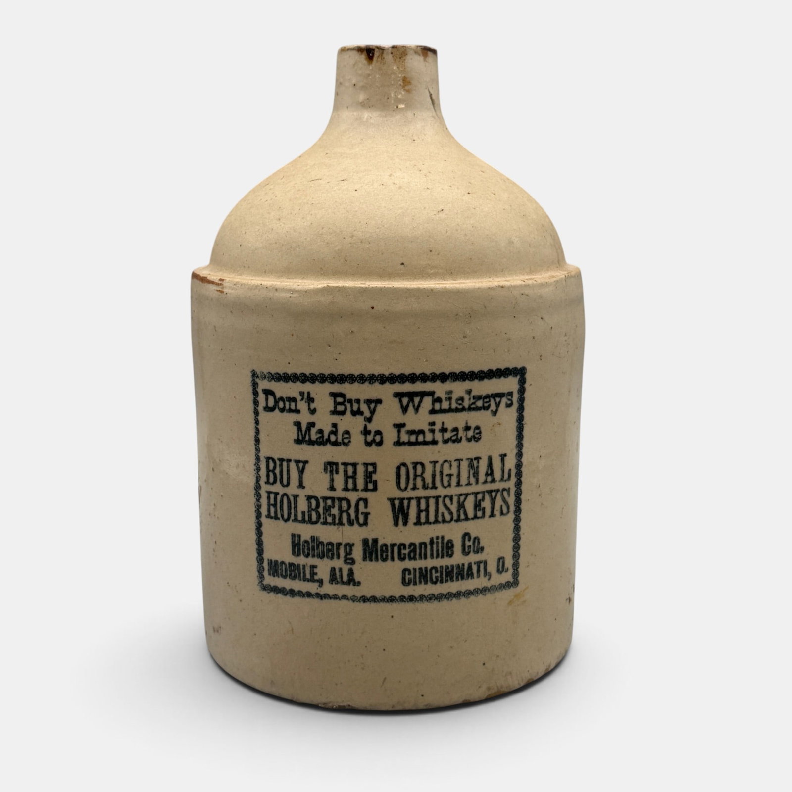 Whiskey jug made for Holberg Mercantile Co. Cincinnati: Whiskey jug made for the Holberg Mercantile Co. Mobile, Ala. and Cincinnati, O. On the label is the admonition "Don't Buy Whiskeys Made to Imitate. Buy the Original Holberg Whiskey's. Height 10 7/8