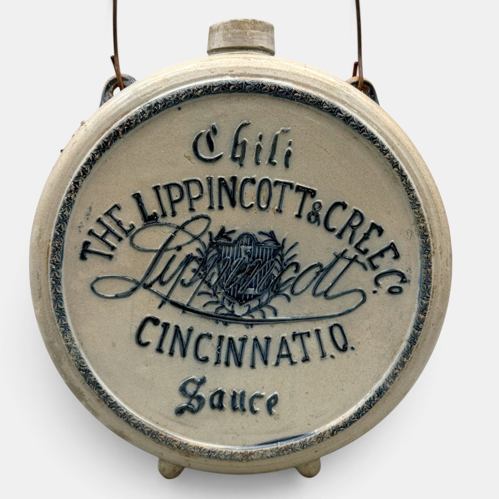 Lippincott and Cree Chili Sauce Stoneware Jug: Lippincott and Cree Cincinnati Chili Sauce flat sided jug. Decorated in cobalt blue with two small handles connected with a wire bail. Cobalt blue decoration to sides. Label reading "Chili sauce is