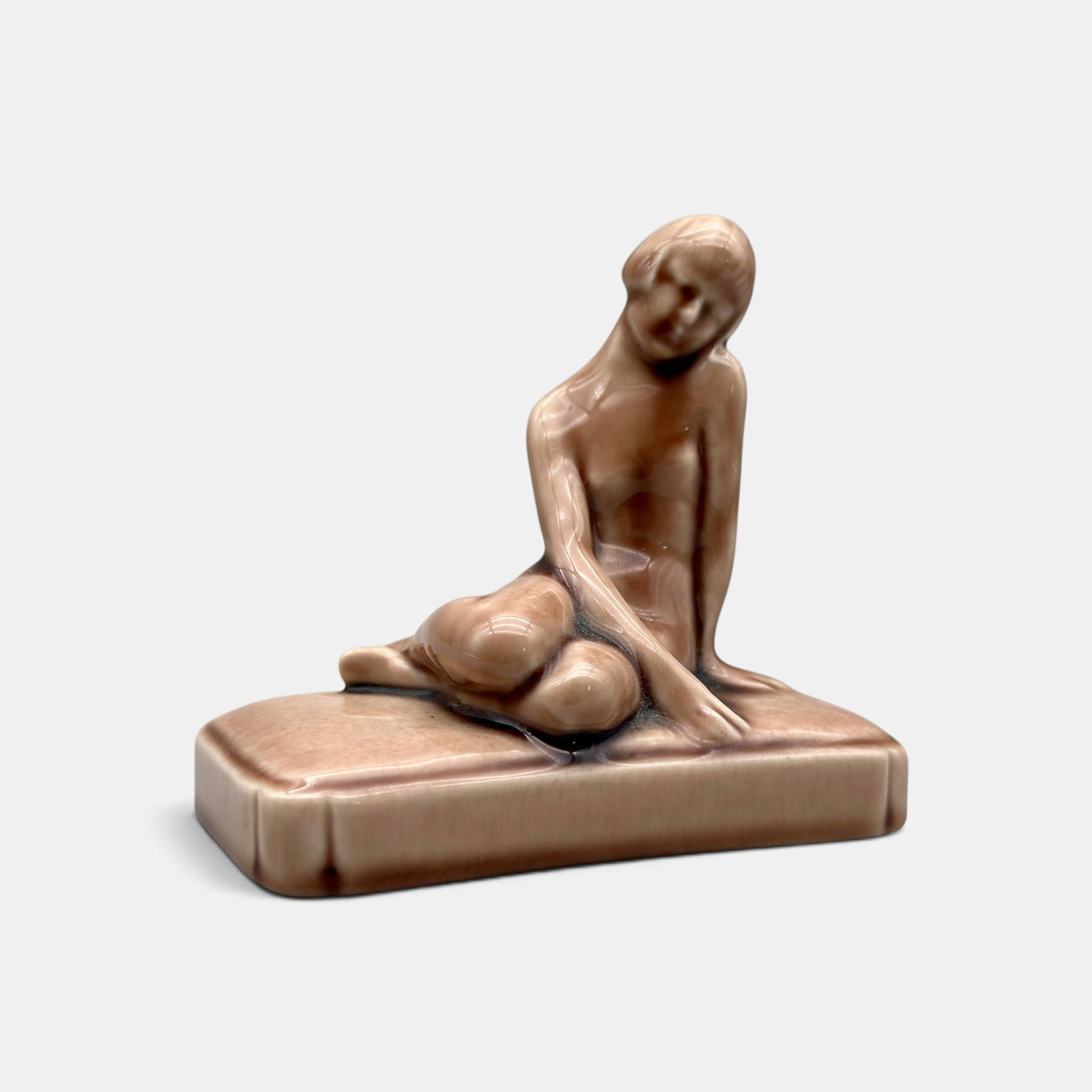 Rookwood Nude paperweight, 1953: Rookwood Nude paperweighy, a Louise Abel design, done in Wine Madder glaze i n1953. Impressed Rookwood logo, LIII, Shape number 2868 along with Abel's cast monogram. Height 4 1/4 inches.