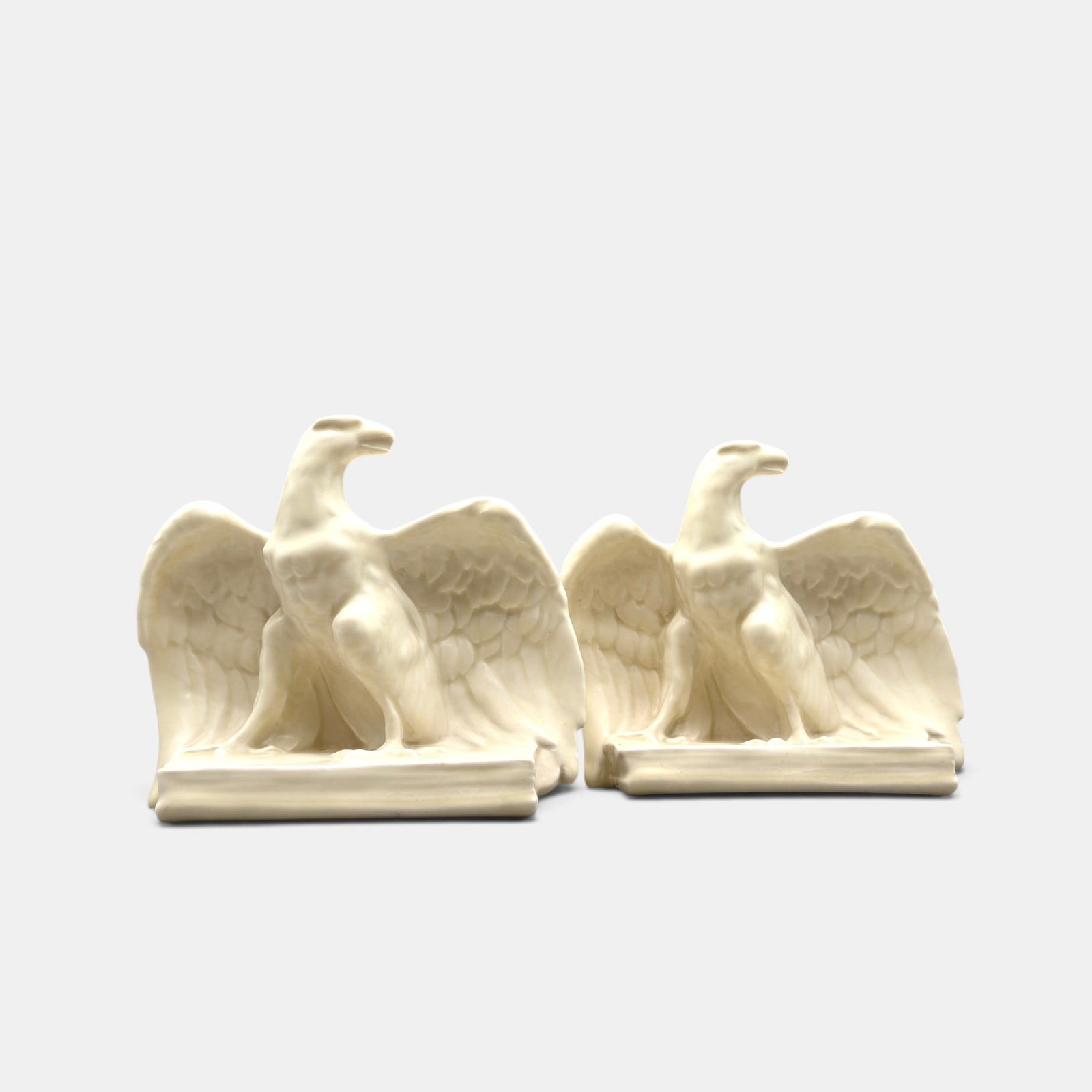 Pair of Rookwood Eagle bookends, 1945: Pair of Rookwood Eagle bookends, a William McDonald design, done in white mat glaze in 1945. Impressed Rookwood logo, XLV, Shape number 2623, McDonald's cast monogram on back. Height 6 1/4 inches. Whe